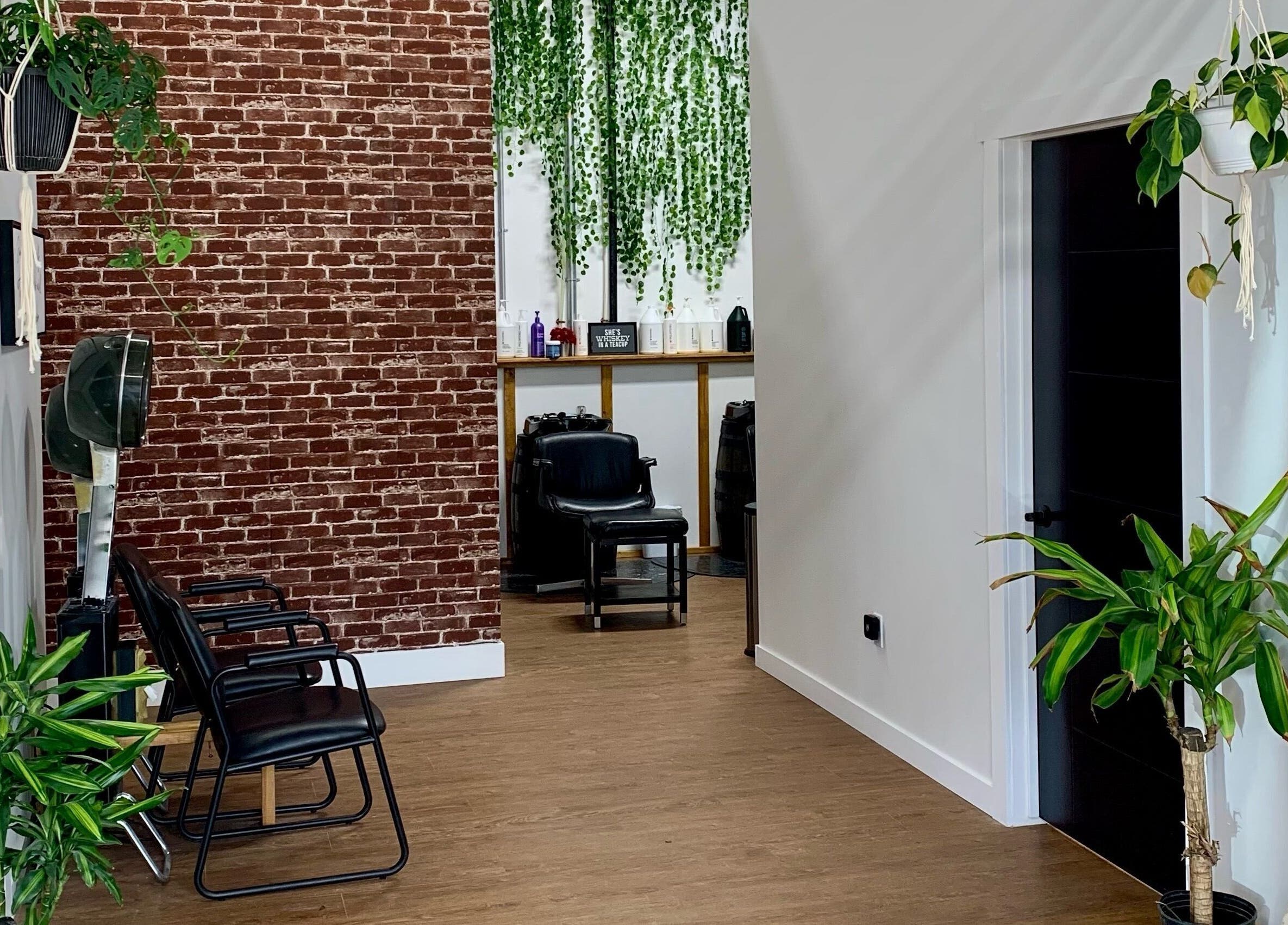Stylish interior of Turning Heads Hair Studio in Calgary, Alberta, CA with modern chairs and vibrant plants.
