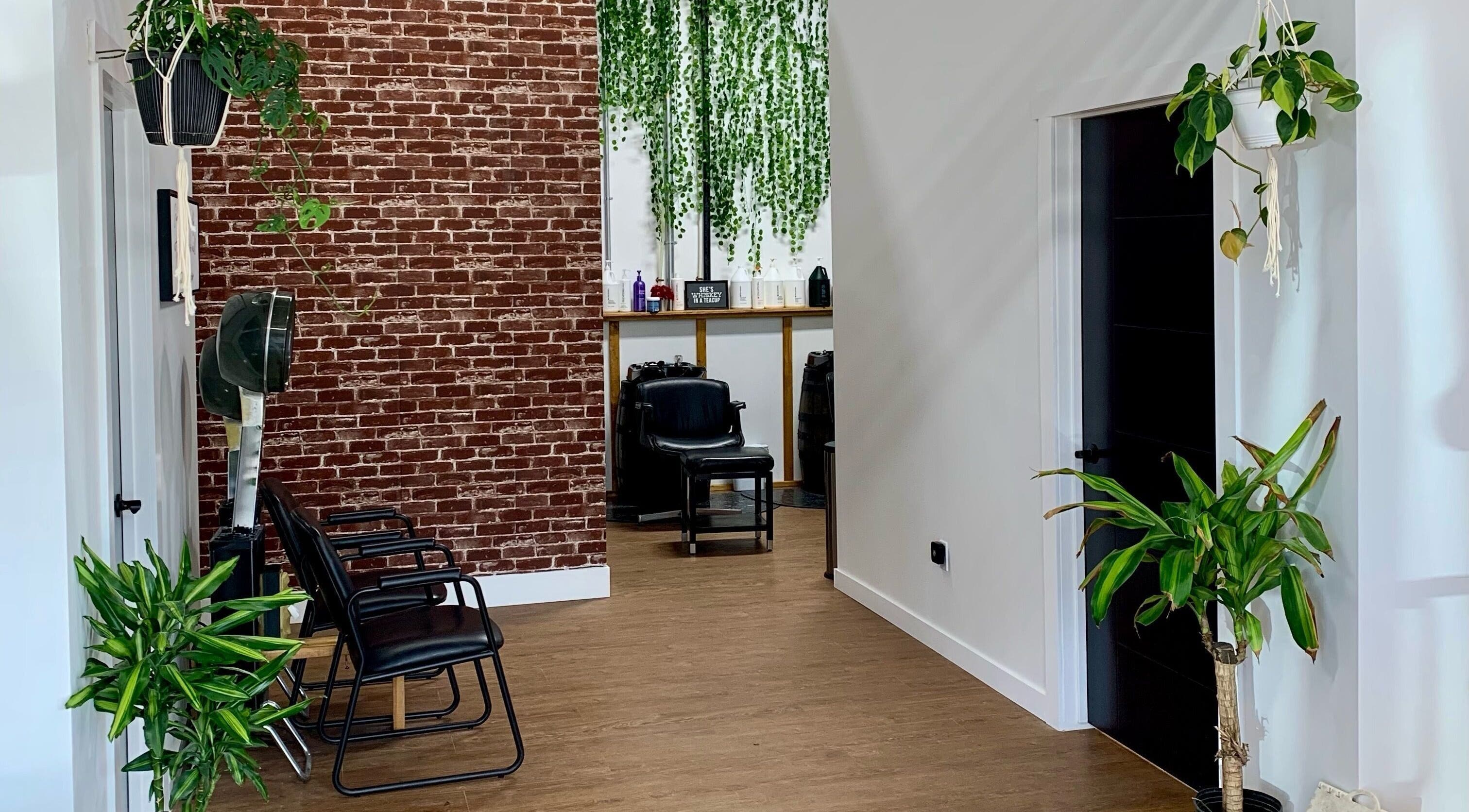 Stylish interior of Turning Heads Hair Studio in Calgary, Alberta, CA with modern chairs and vibrant plants.