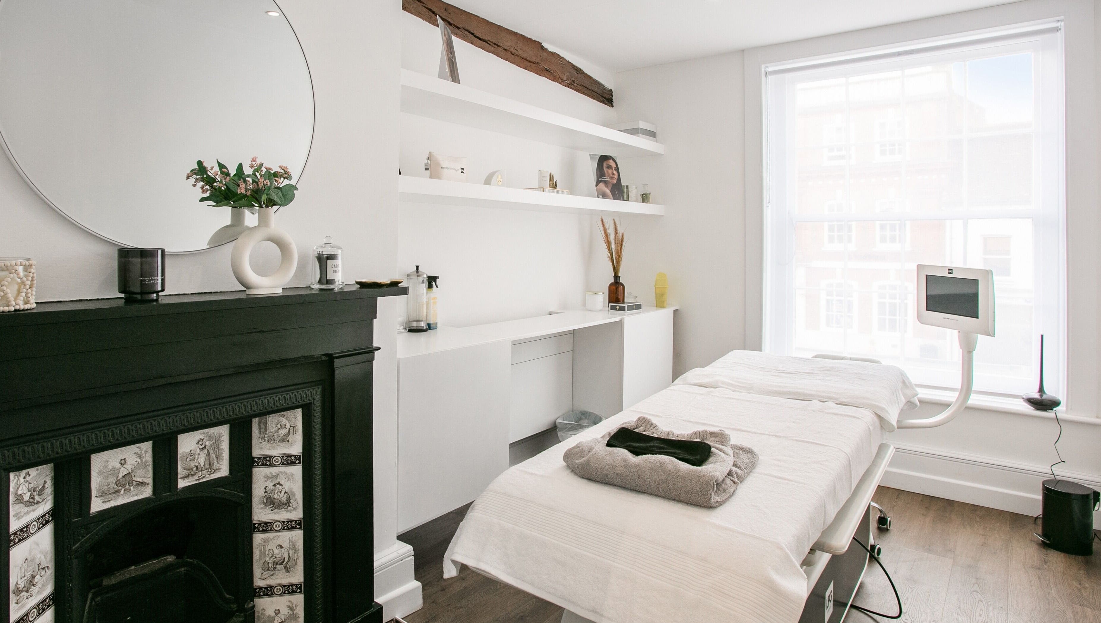Chic beauty room at Forfacesakeuk, HIGH WYCOMBE, England, GB with bright decor and massage table.