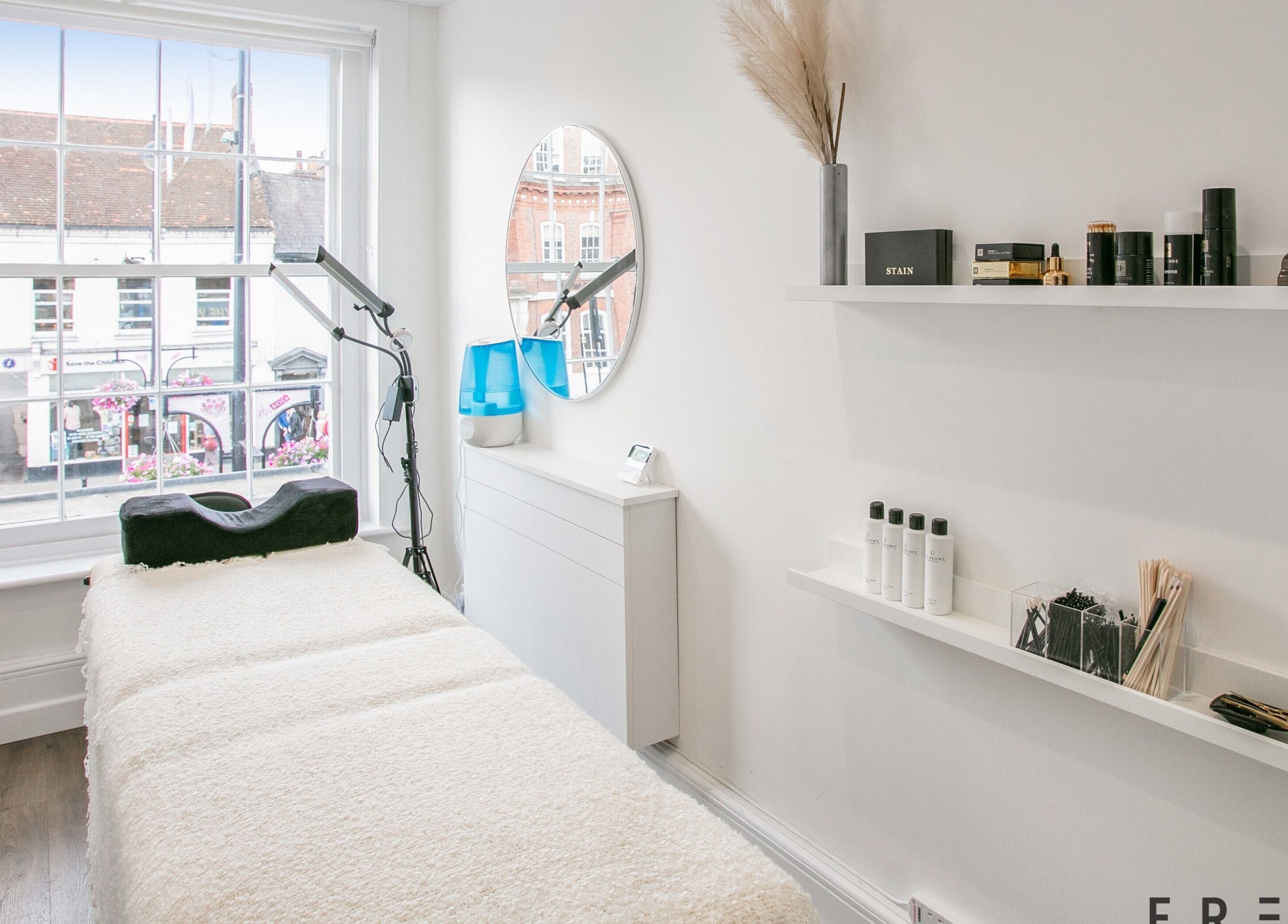 Tranquil treatment room at Forfacesakeuk, HIGH WYCOMBE, England with modern decor and large window view.