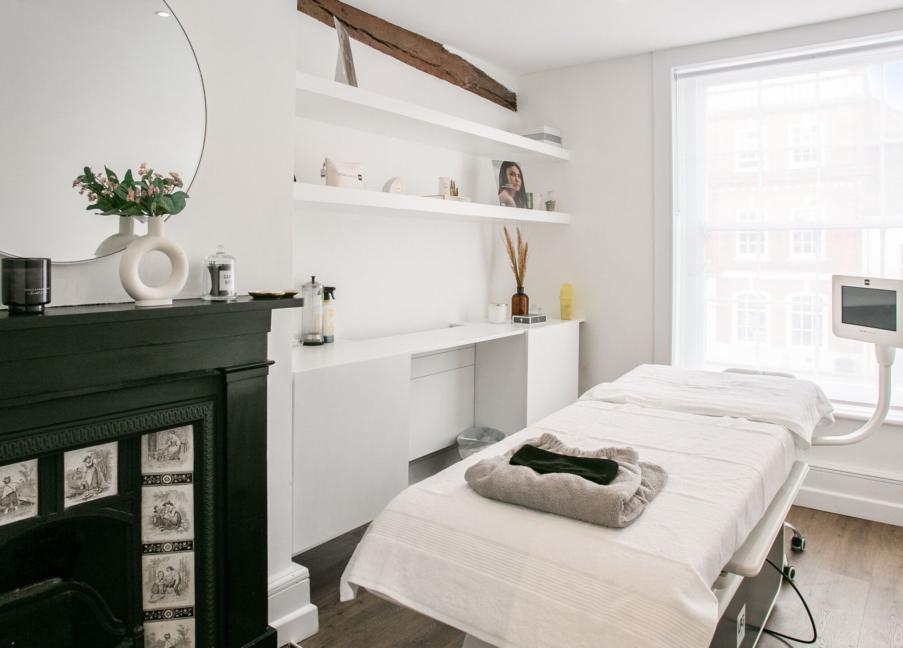 Elegant spa room at Forfacesakeuk in HIGH WYCOMBE, England, GB, featuring a comfortable treatment bed and stylish decor.