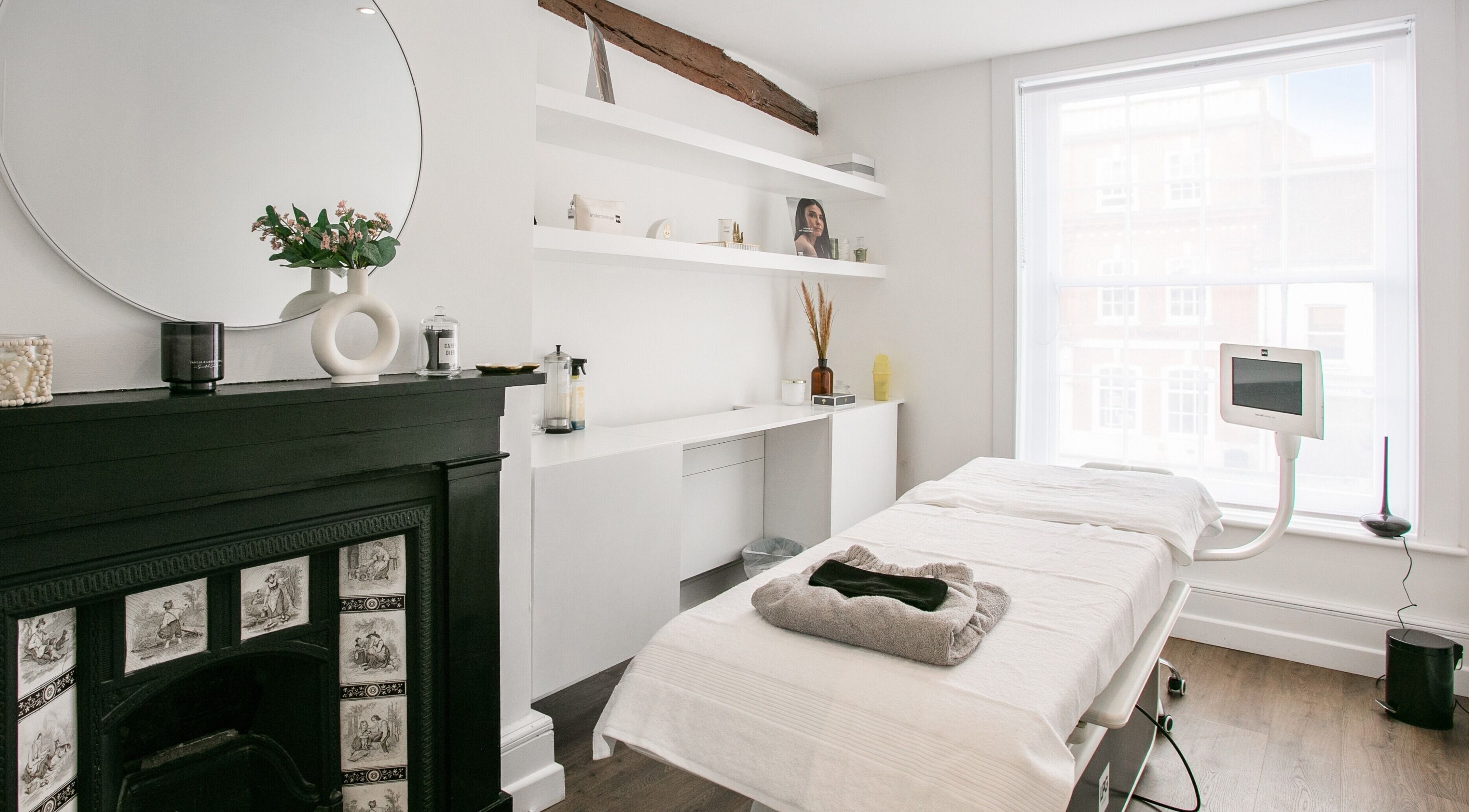 Elegant spa room at Forfacesakeuk in HIGH WYCOMBE, England, GB, featuring a comfortable treatment bed and stylish decor.
