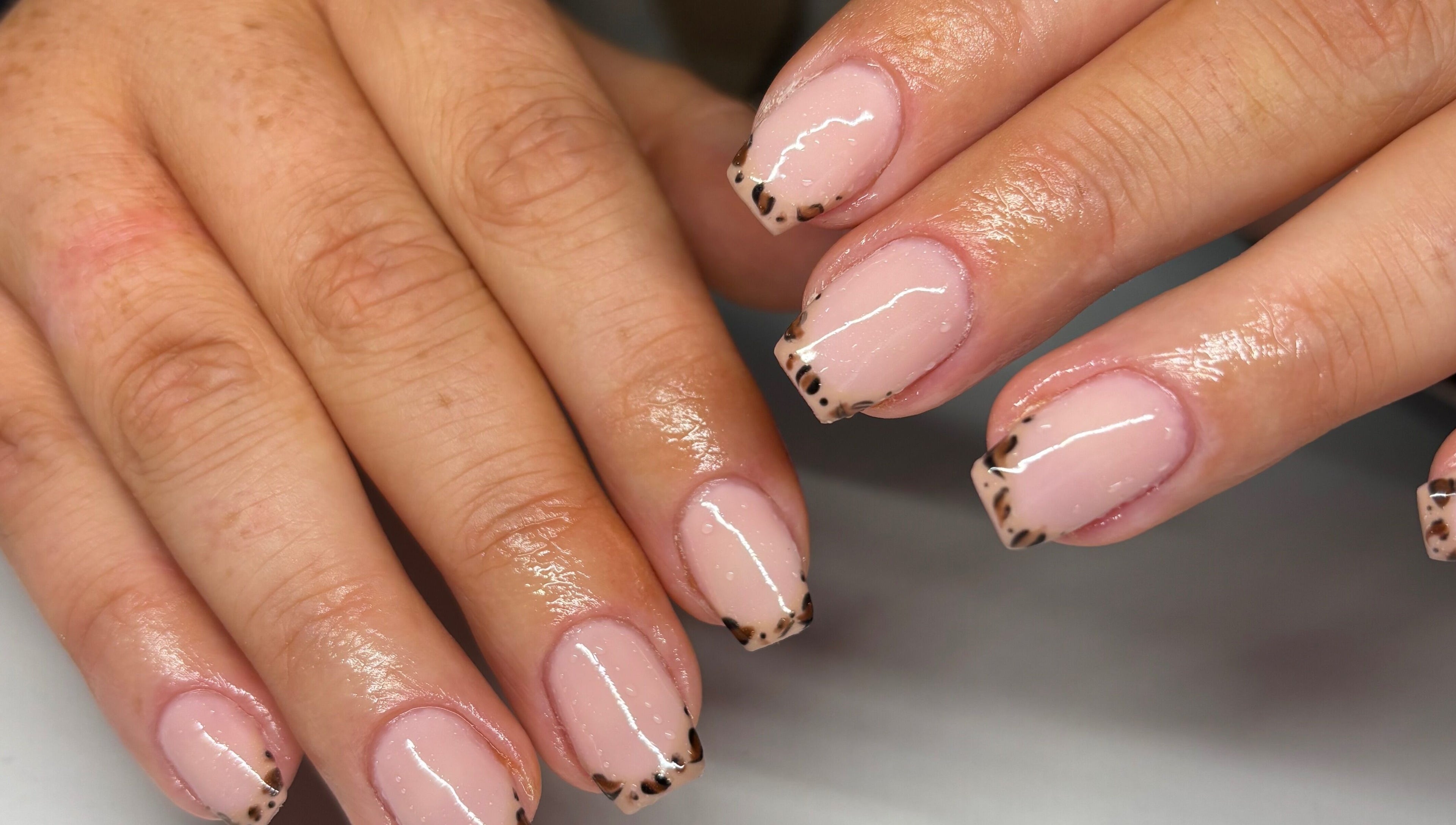Elegantly painted leopard French tips at Nails by Em, Gloucester, England, GB.