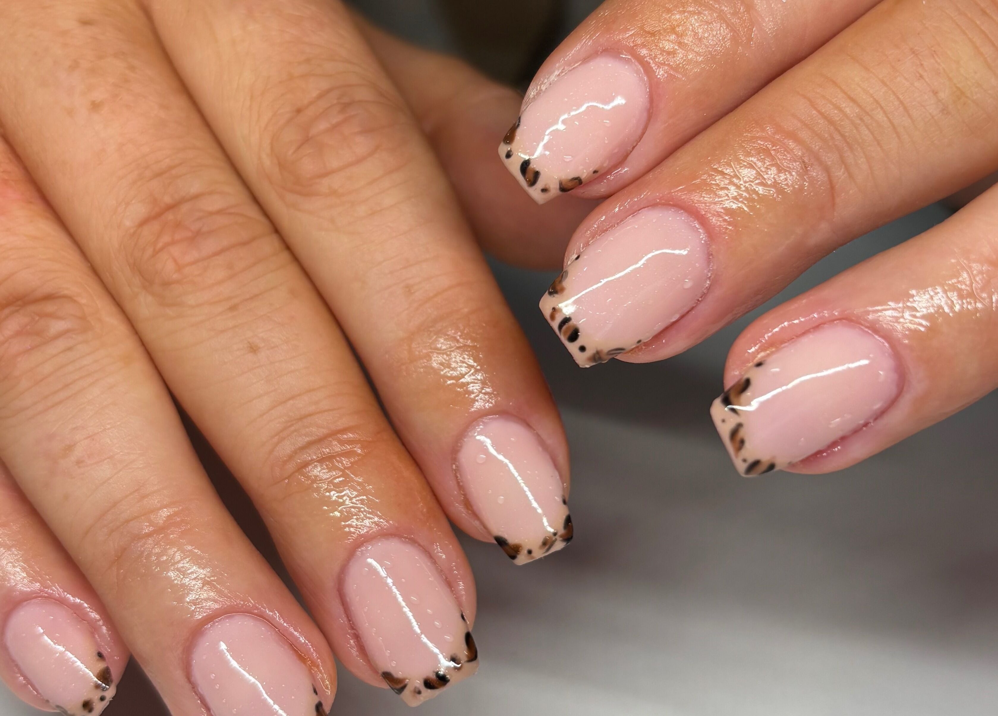 Elegantly painted leopard French tips at Nails by Em, Gloucester, England, GB.