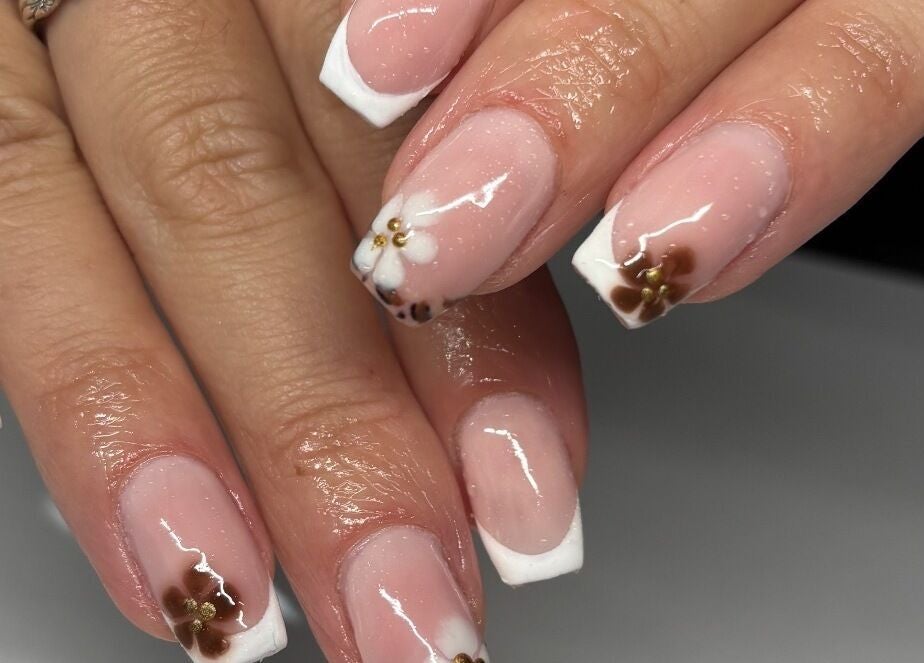 Elegant French manicure with floral designs by Nails by Em, Gloucester, England, GB.
