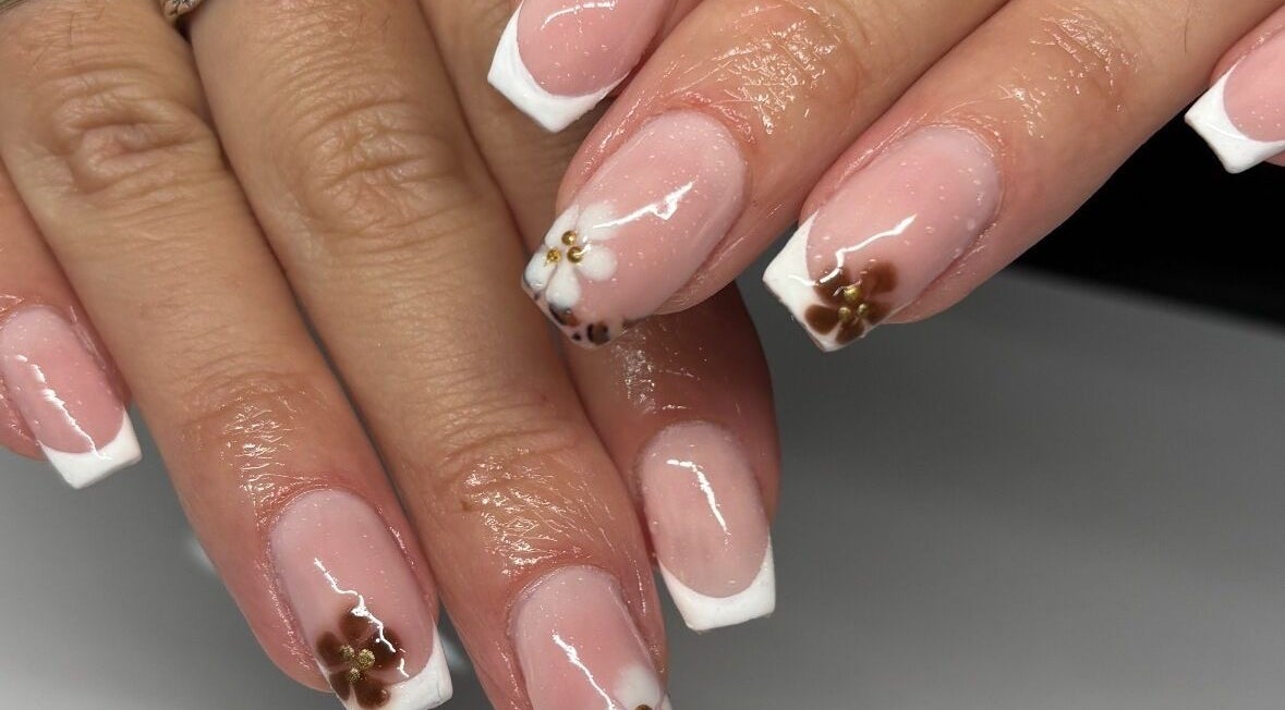 Elegant French manicure with floral designs by Nails by Em, Gloucester, England, GB.
