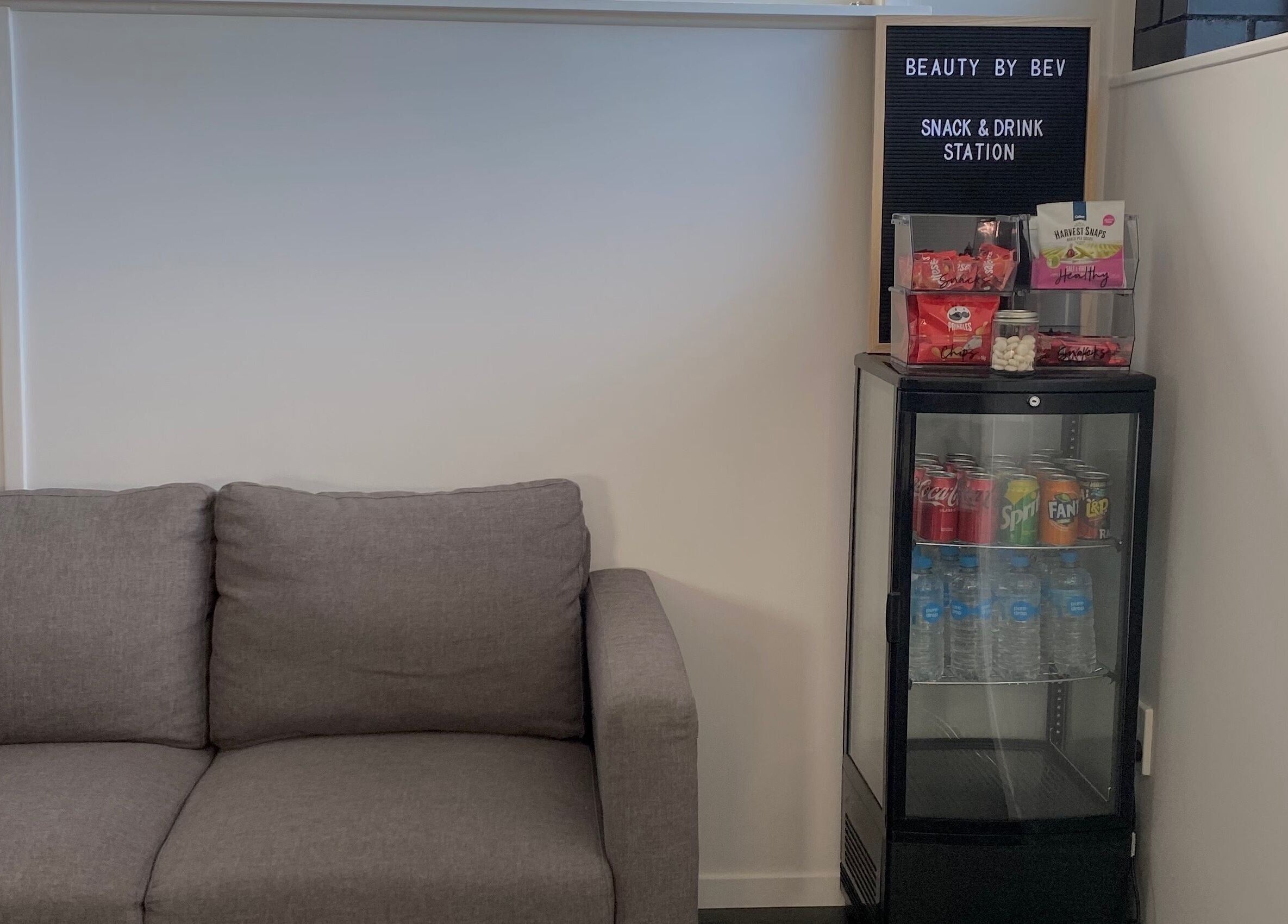 Cozy snack and drink station at Beauty By Bev in Levin, Manawatu-Wanganui, NZ, featuring a comfy couch.
