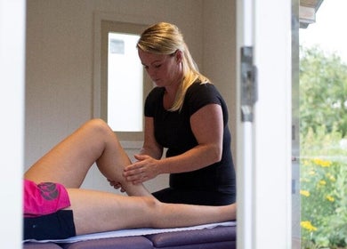 Massage therapist at CJ Soft Tissue & Massage Therapy in Wellington, England, provides leg therapy.