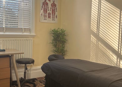 Calm massage room at CJ Soft Tissue & Massage Therapy, Wellington, England, GB with natural light and decor.