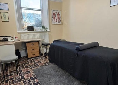 Massage therapy room at CJ Soft Tissue & Massage Therapy, Wellington, England with massage table and serene decor.