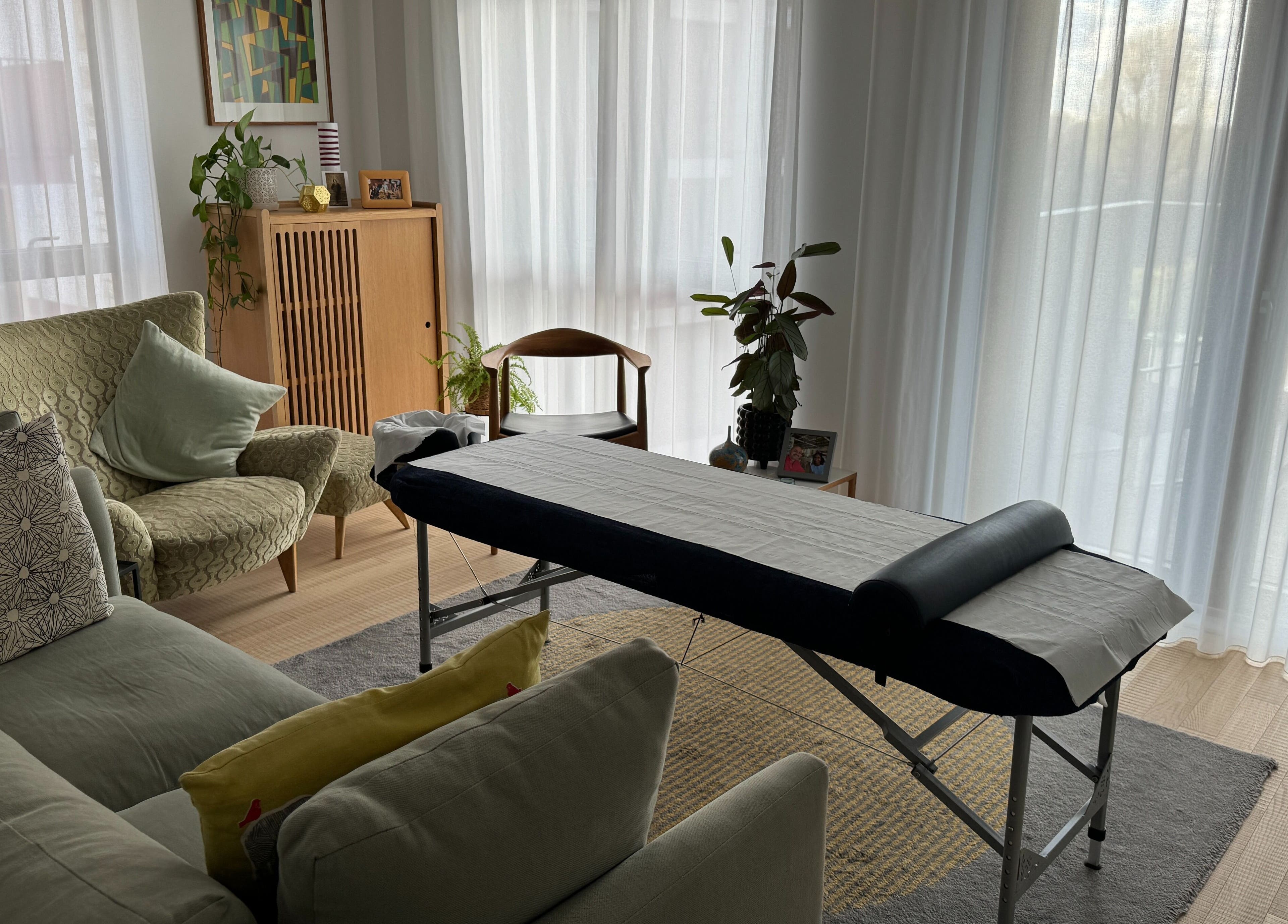Cozy living room with massage table at Paul Massage at Home, Home Service, GB.