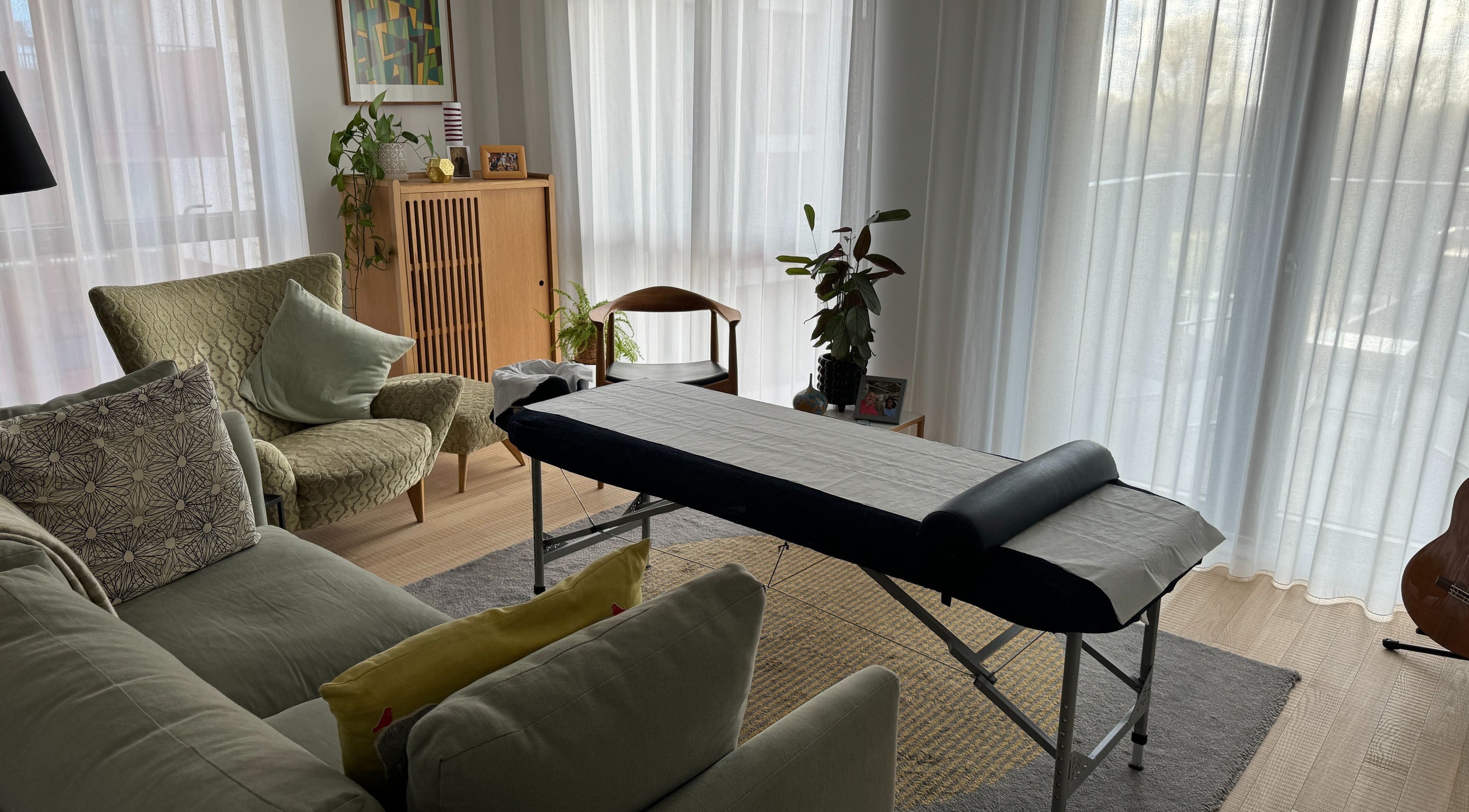 Cozy living room with massage table at Paul Massage at Home, Home Service, GB.