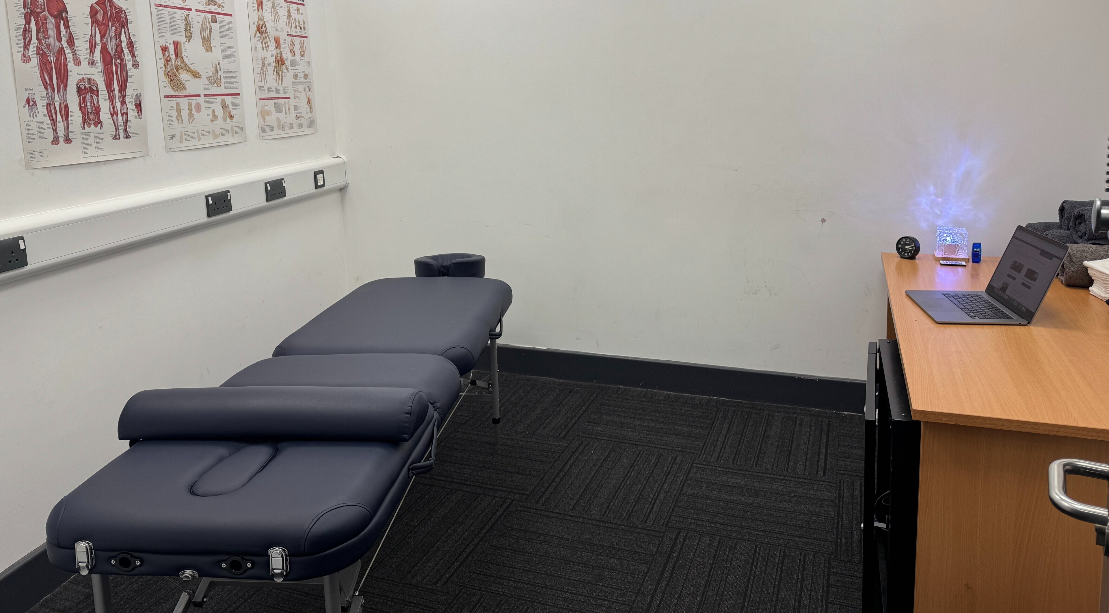 Massage room at Paul Massage, Langley Leisure Centre, Slough, England, featuring a therapy bed and modern decor.