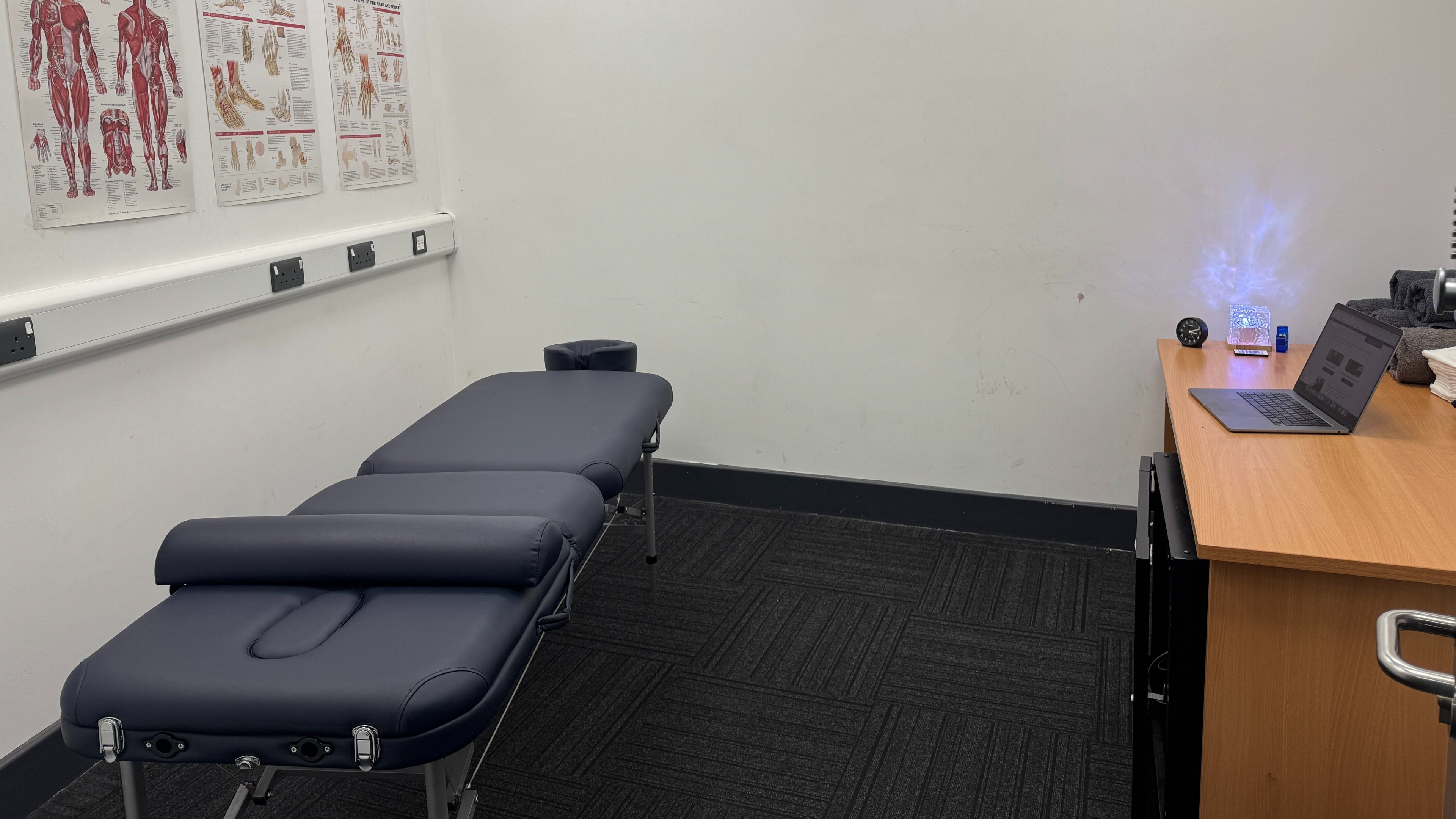 Massage room at Paul Massage, Langley Leisure Centre, Slough, England, featuring a therapy bed and modern decor.