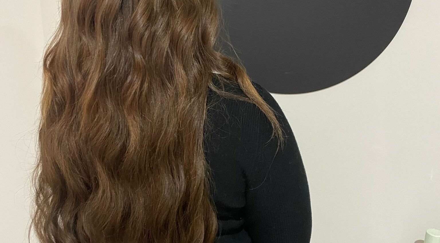 Wavy brown hair styled at Hair Extensions by Natalie in Gisborne, Victoria, AU.