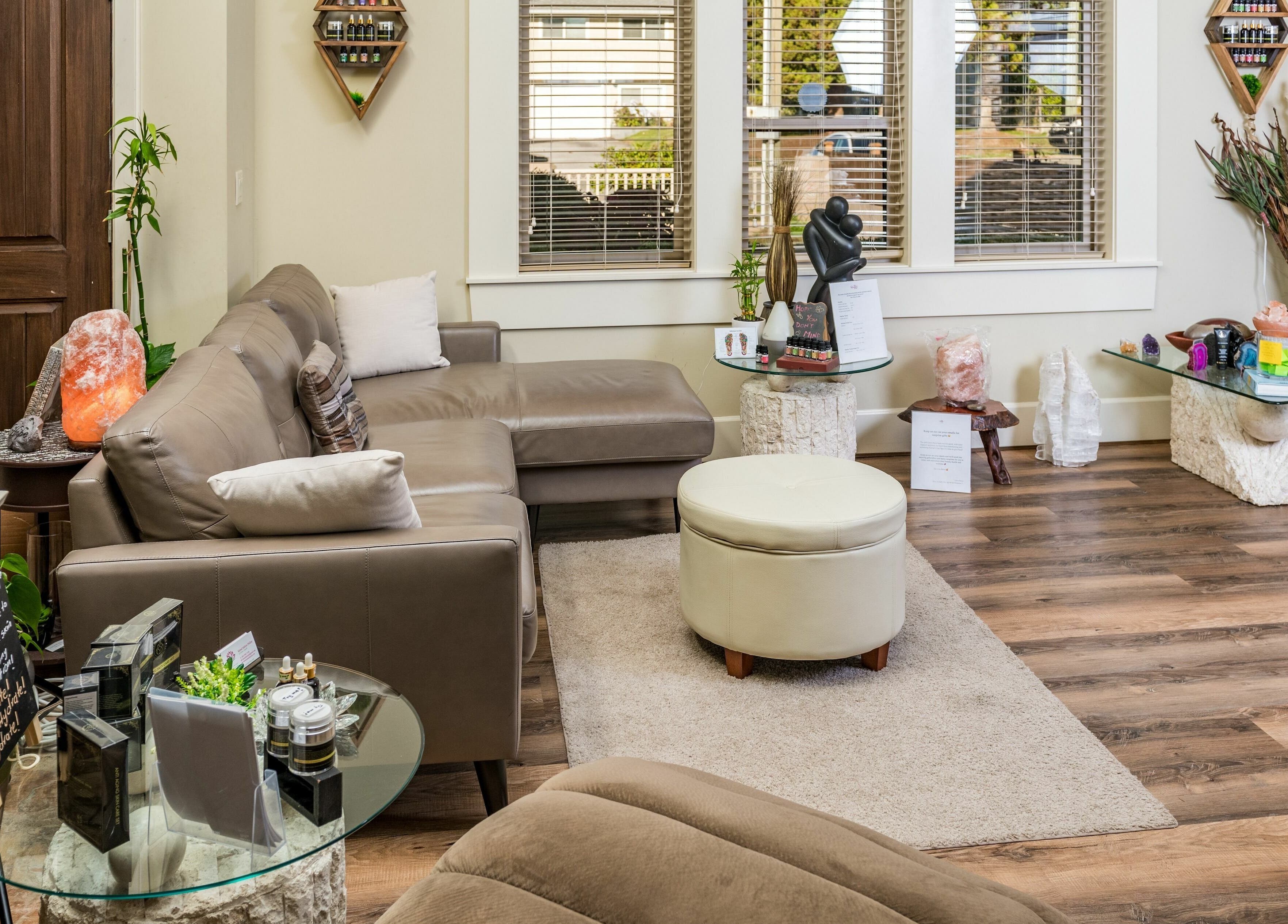 Relaxing lounge area at Kamal's Day Spa, Delta, BC, CA, featuring cozy seating and warm decor.