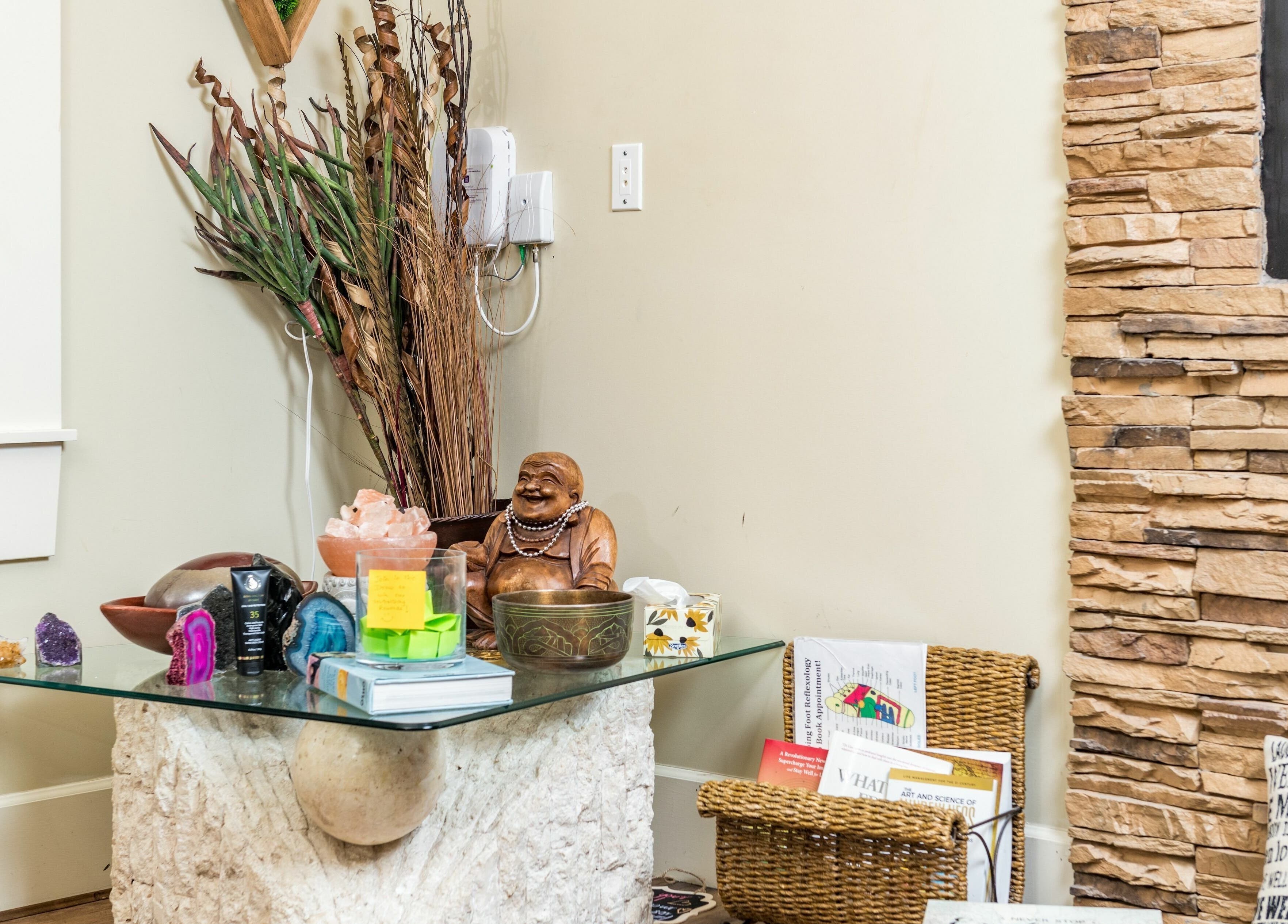 Relaxing corner with decor at Kamal's Day Spa, Delta, British Columbia, CA, featuring serene statues and crystals.
