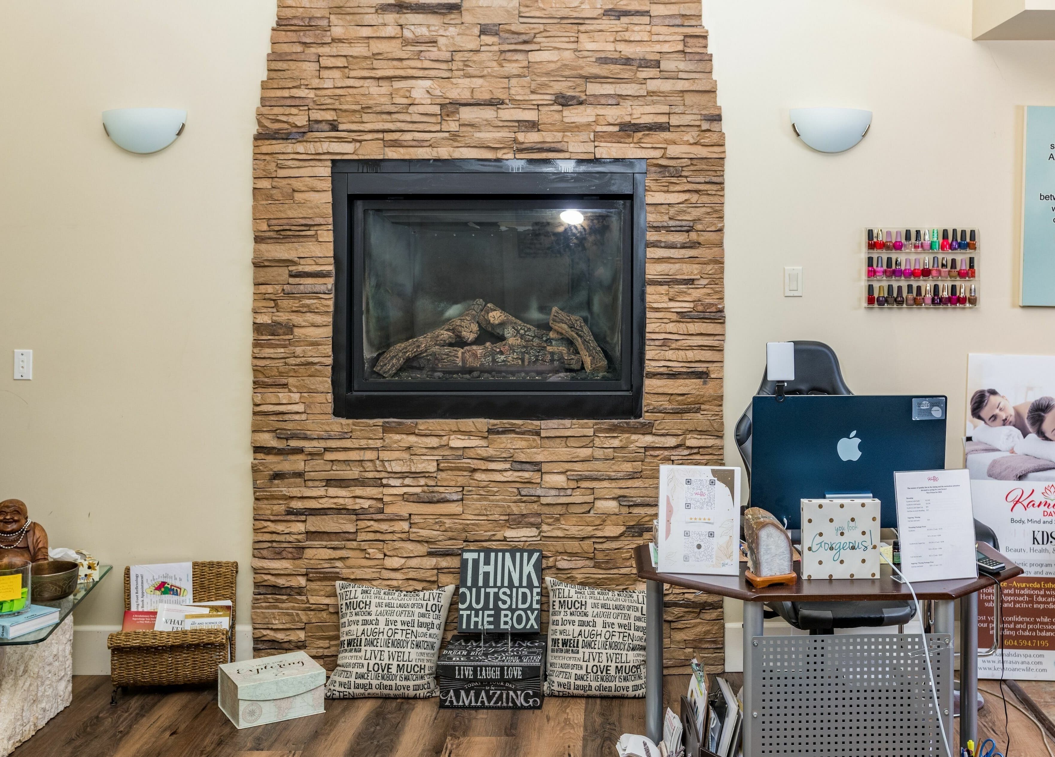 Relaxing waiting area at Kamal's Day Spa, Delta, British Columbia, CA with a warm stone fireplace.