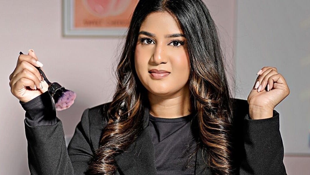 Makeup artist at The Beauty Spot, Queensburgh, Kwazulu-natal, ZA, holding a brush with confidence.