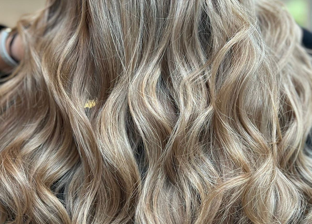 Close-up of luxuriously styled wavy blonde hair at G.C Hair, Crowthorne, England, GB.