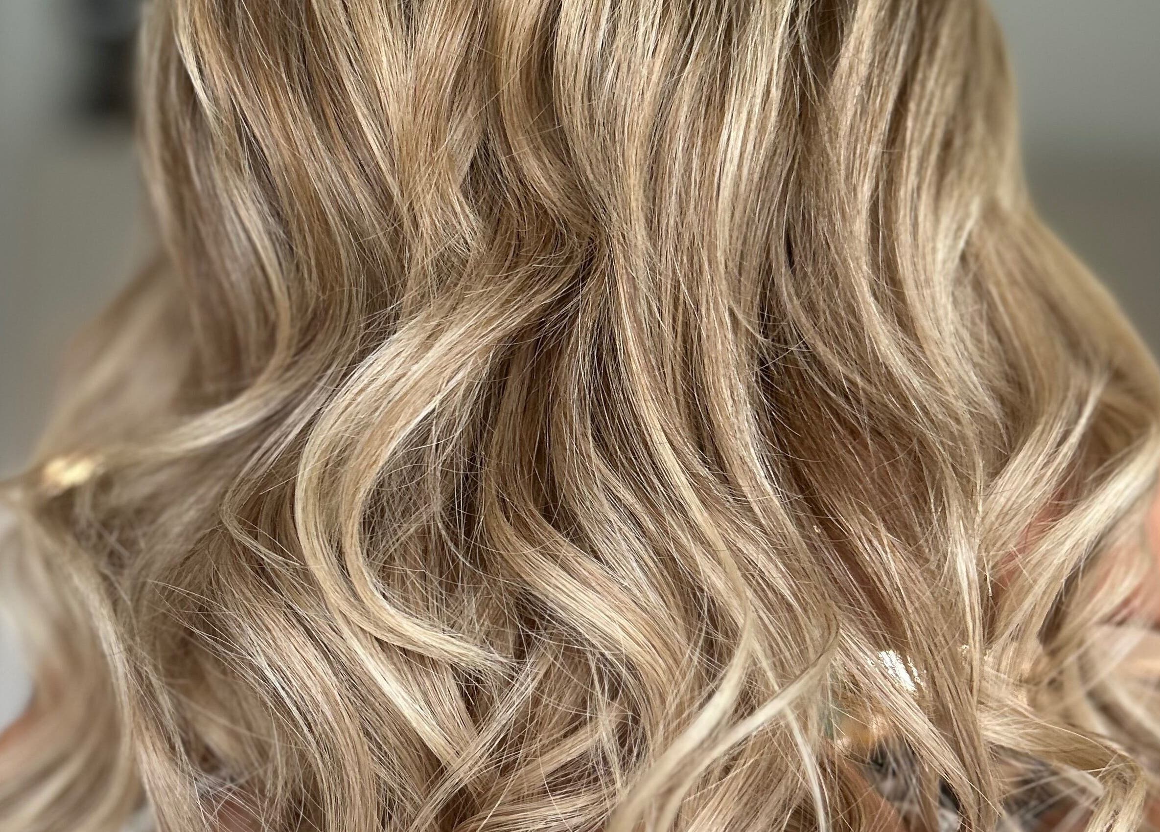 Blonde wavy hairstyle at G.C Hair, Crowthorne, England, GB, showcasing elegant curls.