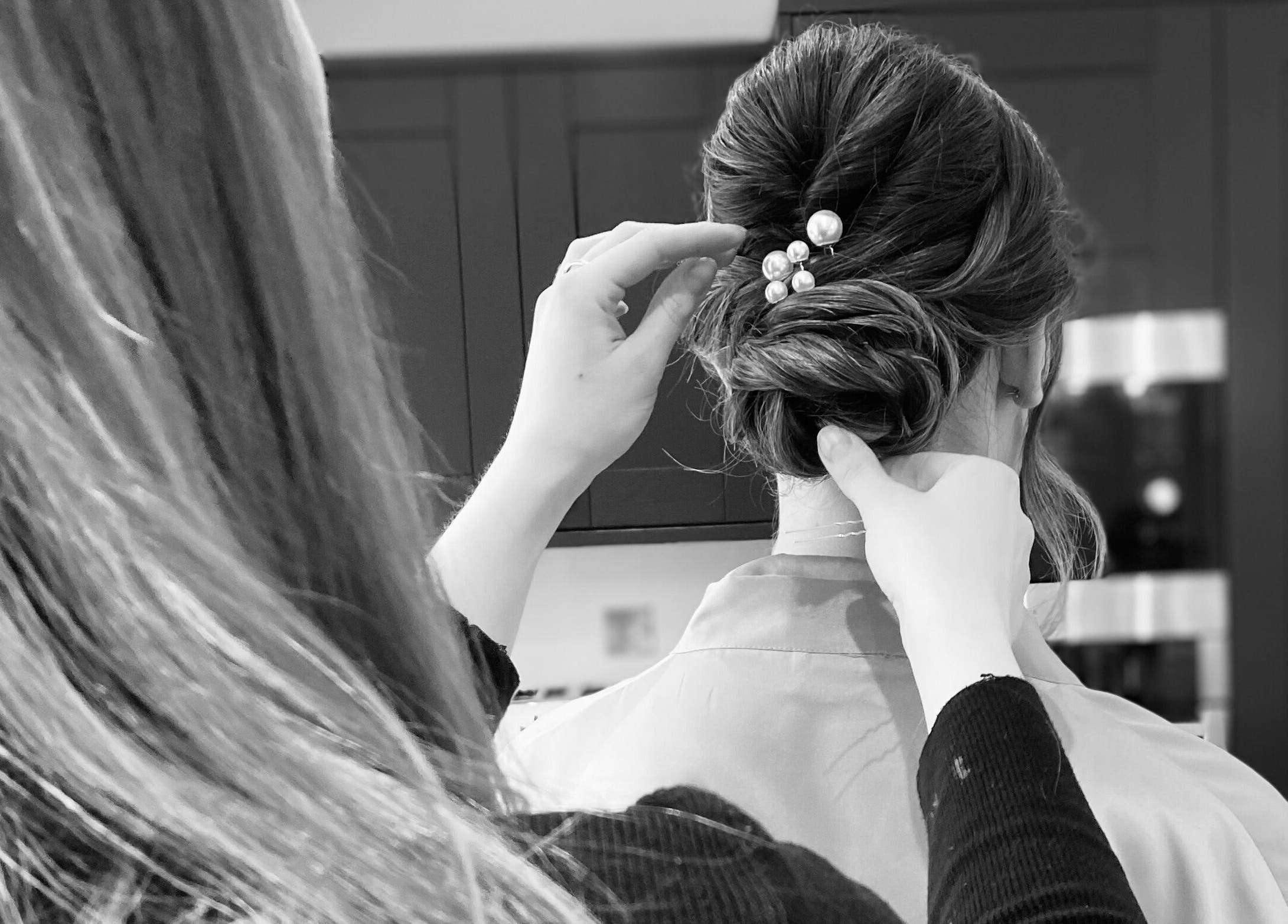 Stylist crafting an elegant updo at G.C Hair, Crowthorne, England, GB.