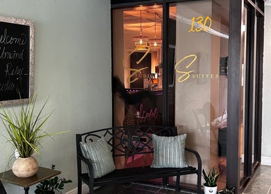 Welcome sign and seating at Neblibana, Mulberry, Florida, US. Entrance features plants and cozy ambiance.