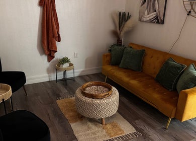 Inviting lounge area at Neblibana, Mulberry, Florida, US featuring a mustard sofa and chic decor.