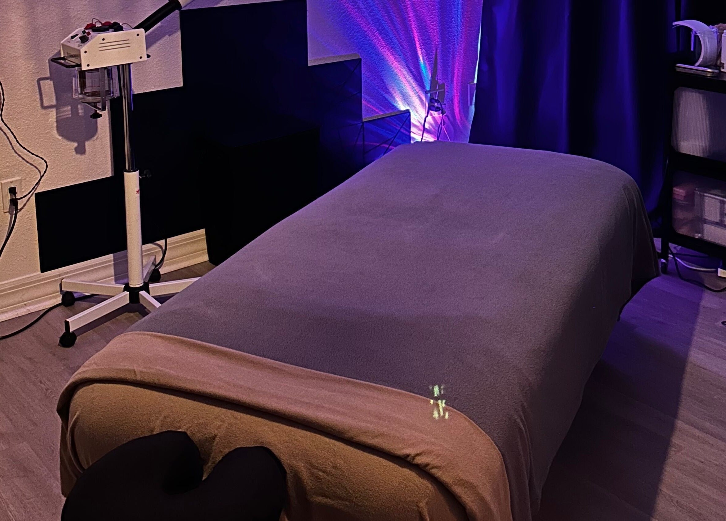 Relaxing massage room at Neblibana, Mulberry, Florida, US, featuring a comfortable massage table and calming lighting.