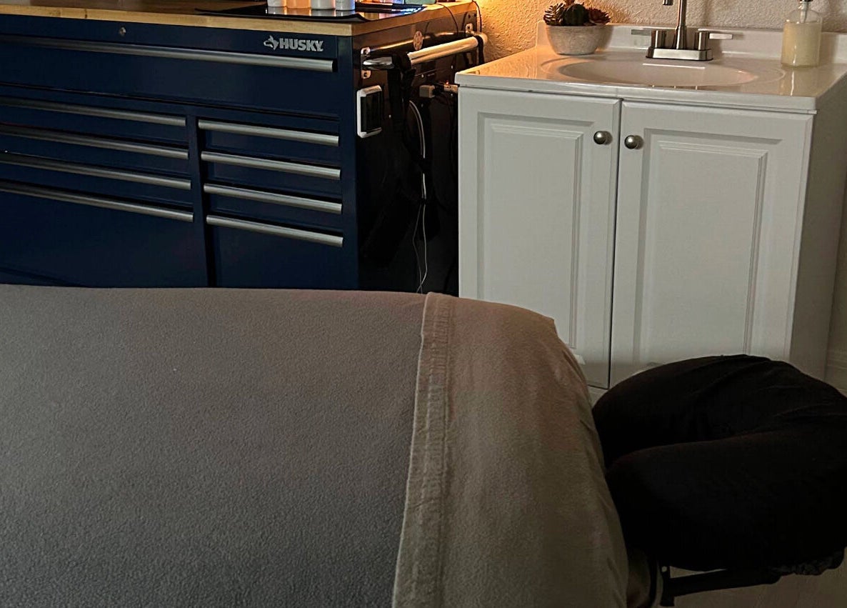 Massage table setup in Neblibana spa, Mulberry, Florida, US with cozy and inviting ambiance.