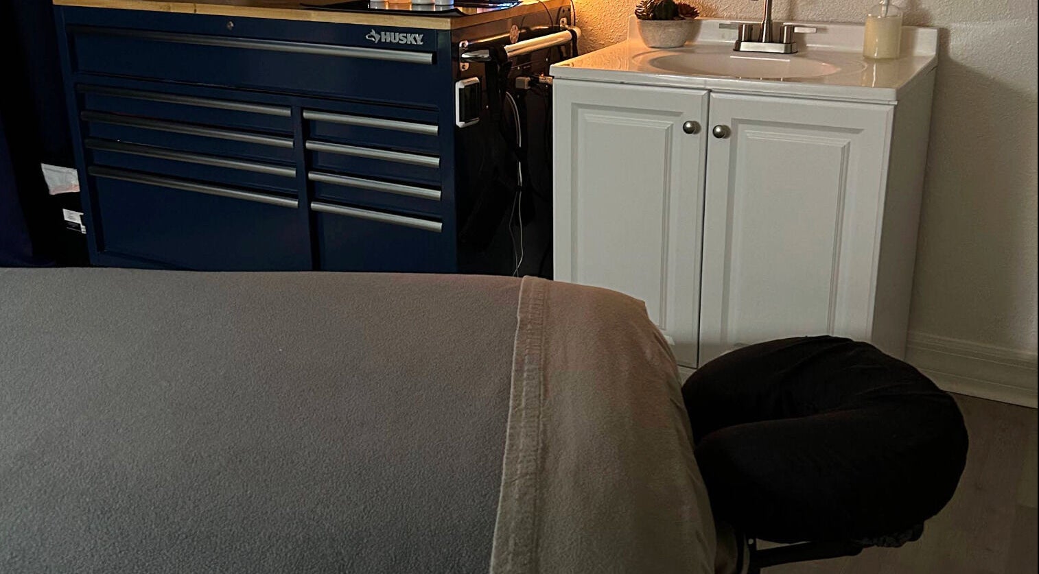 Massage table setup in Neblibana spa, Mulberry, Florida, US with cozy and inviting ambiance.