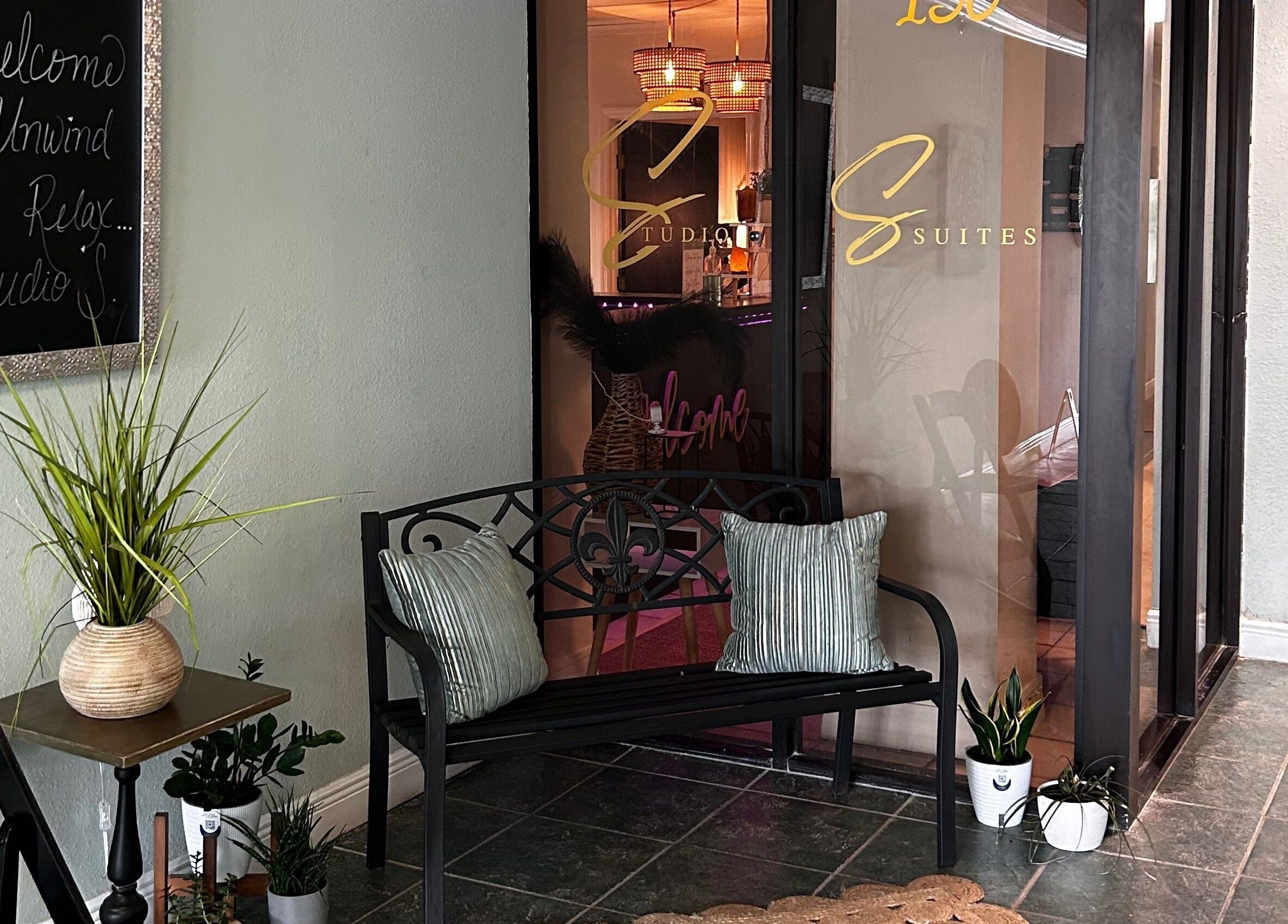 Inviting entrance at Neblibana, Mulberry, Florida, US, featuring a cozy bench and welcoming decor.