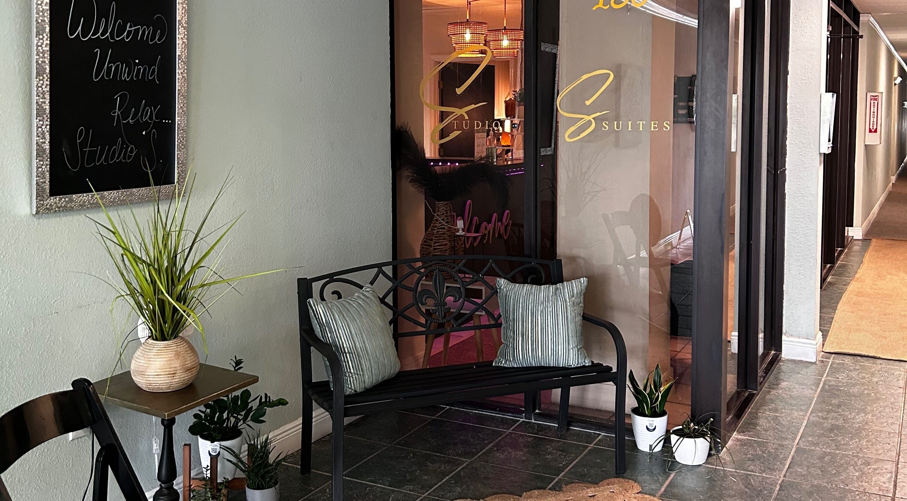 Inviting entrance at Neblibana, Mulberry, Florida, US, featuring a cozy bench and welcoming decor.