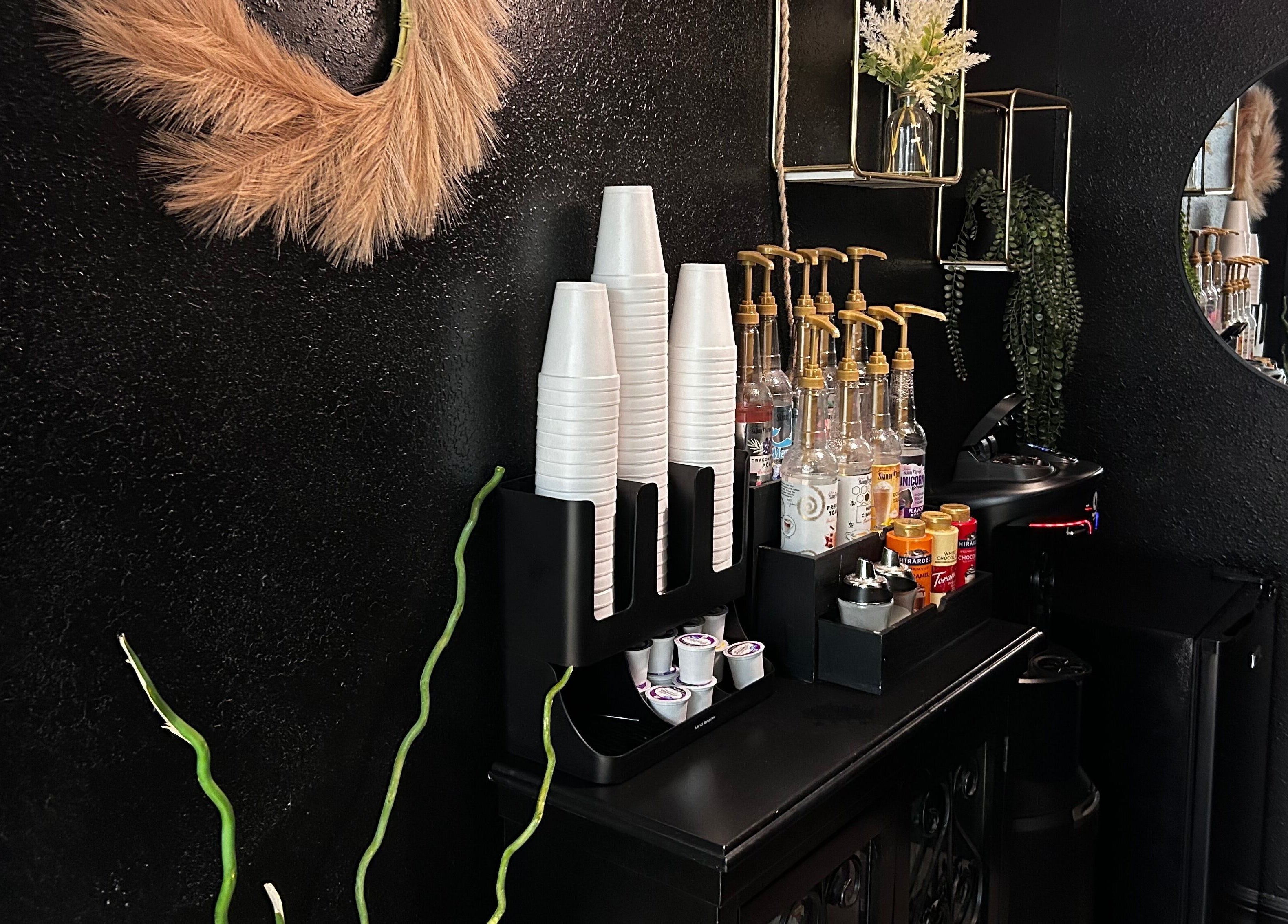 Stylish coffee station at Neblibana, Mulberry, Florida, US, featuring dispensers and decorative elements.