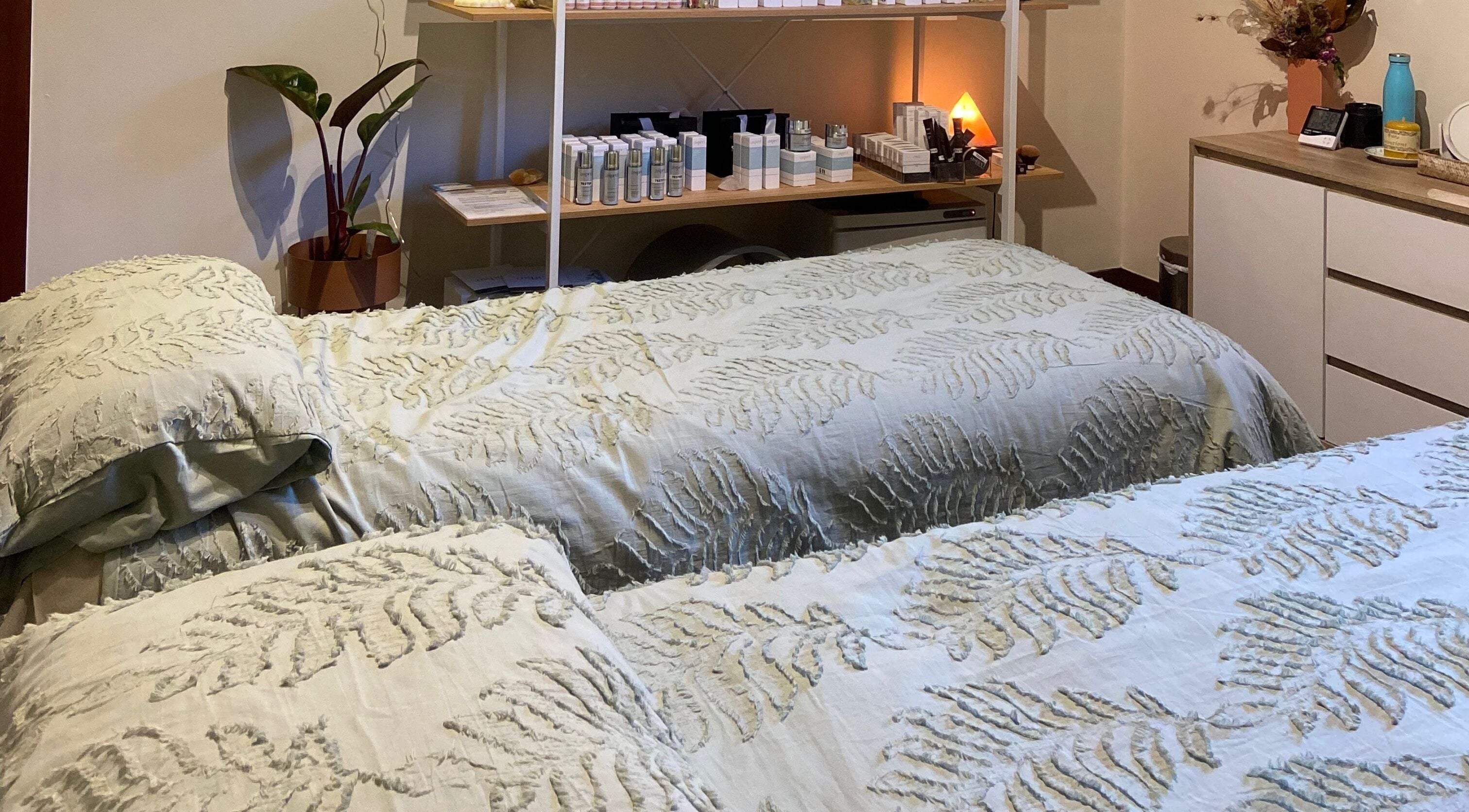 Relaxing treatment room at Bliss Beauty & Wellness, Nelson, NZ with cozy beds and soothing decor.