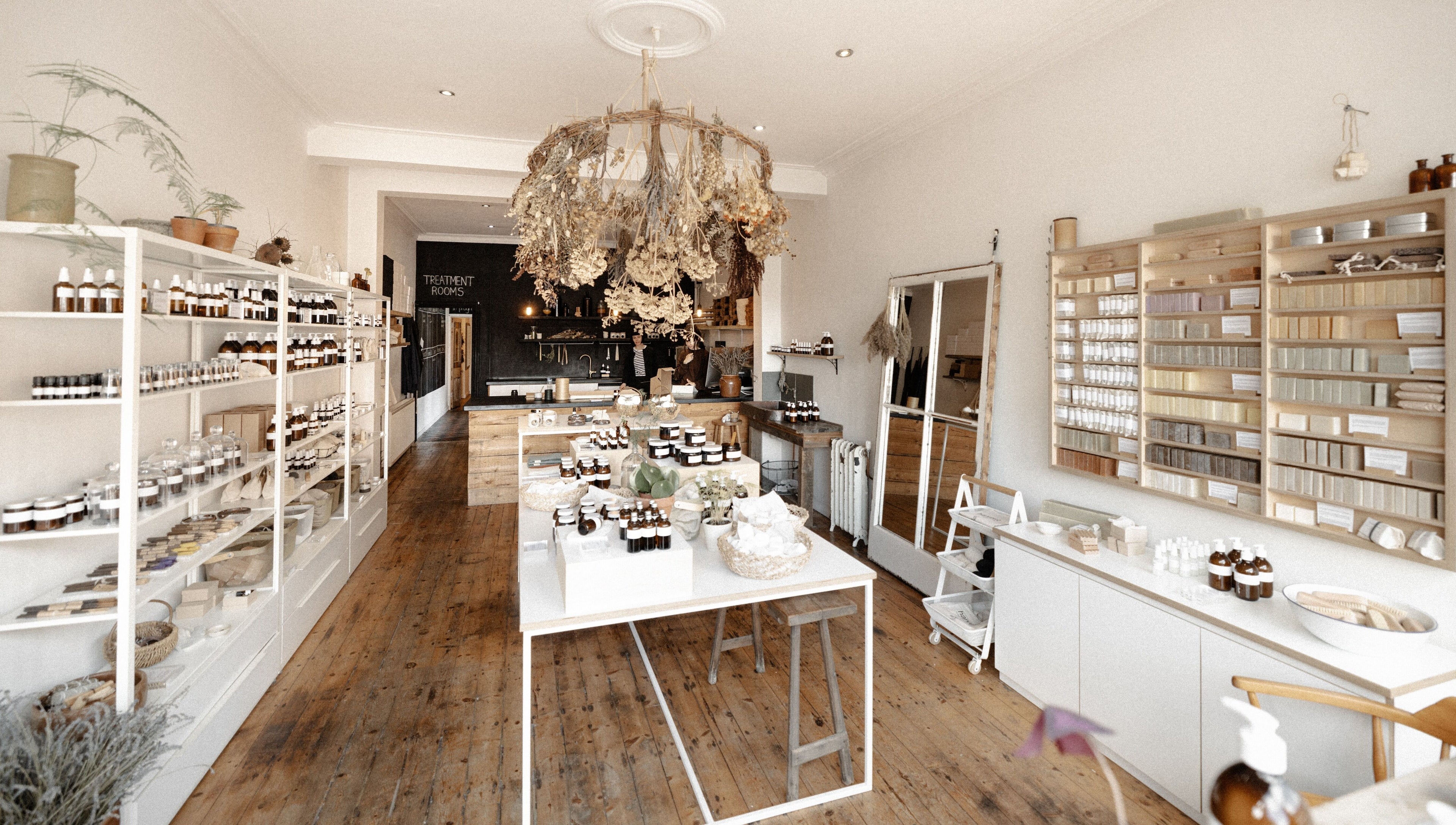 Charming interior of Harvest Skincare in Birmingham, England, showcasing organic products on wooden shelves.