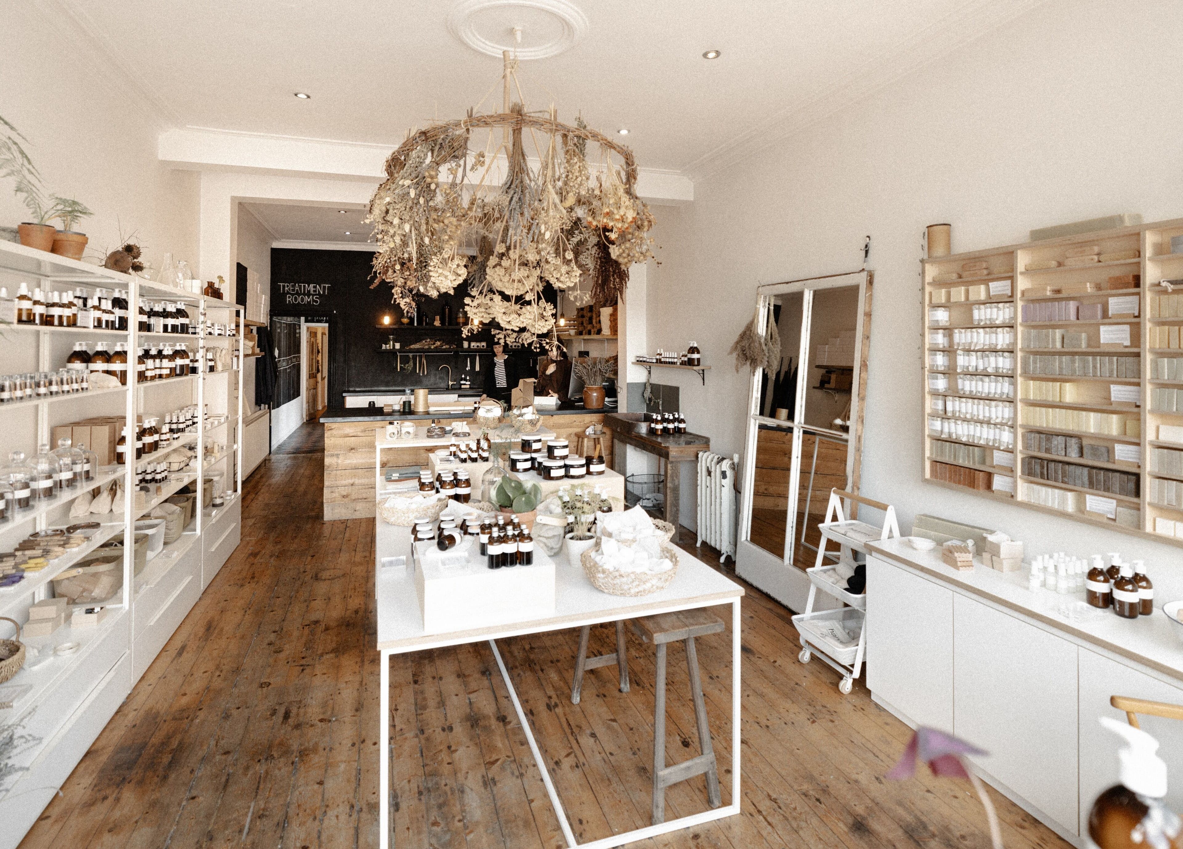 Charming interior of Harvest Skincare in Birmingham, England, showcasing organic products on wooden shelves.