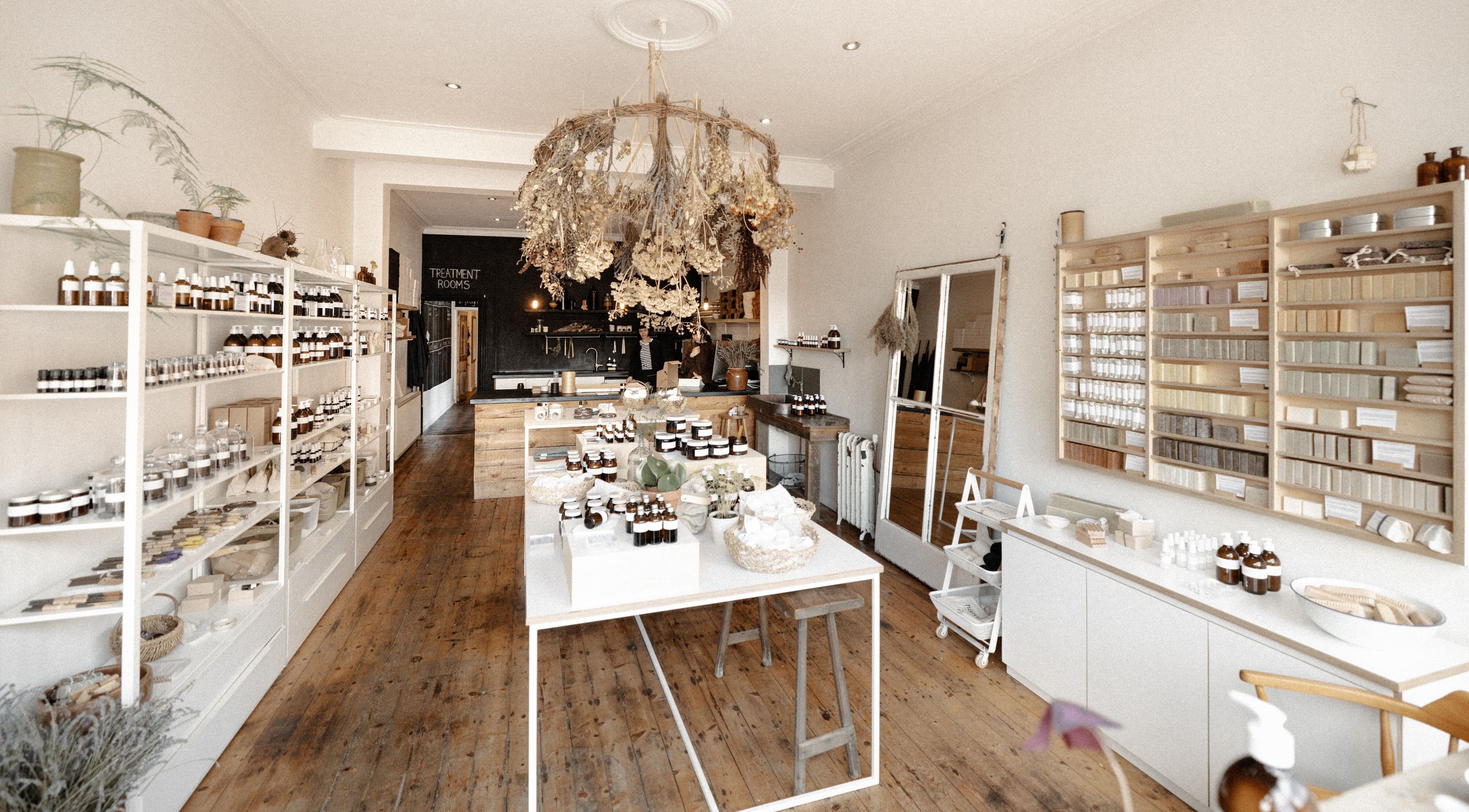 Charming interior of Harvest Skincare in Birmingham, England, showcasing organic products on wooden shelves.