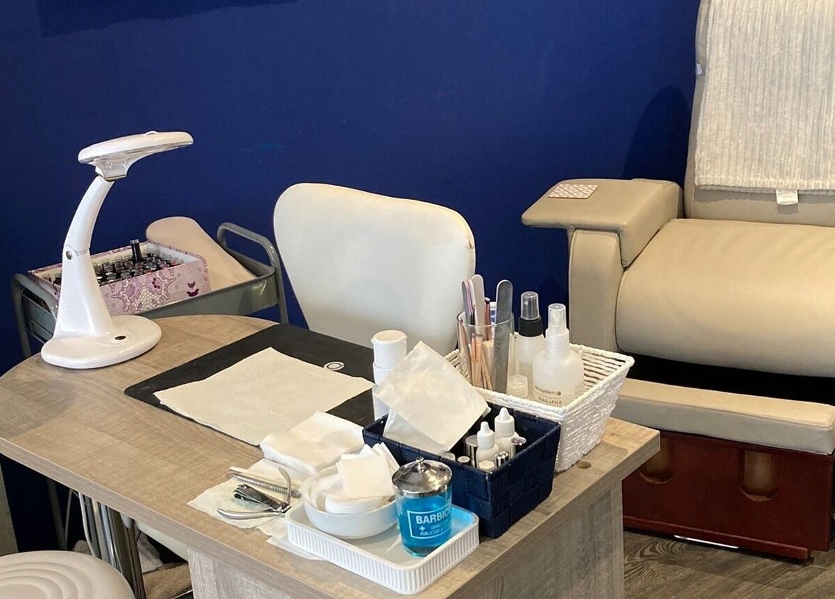 Nail care setup at Canvas, York, England, GB with a cozy chair and manicure tools.