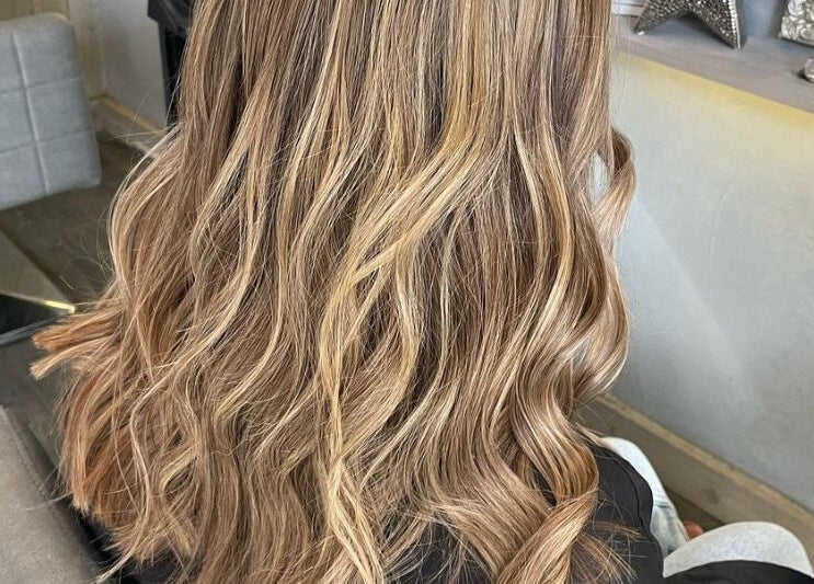 Elegant wavy blonde hairstyle at Canvas, York, England, GB.