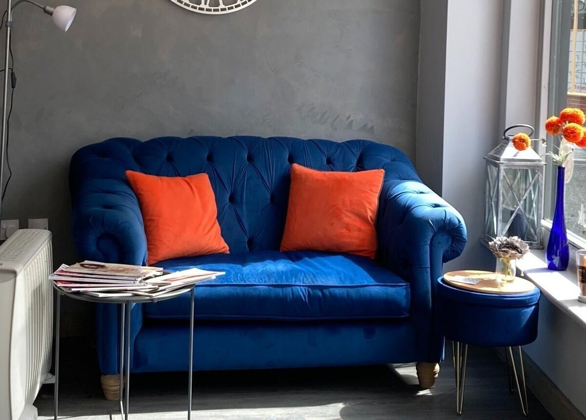 Blue sofa with orange pillows in Canvas lounge at York, England, GB.