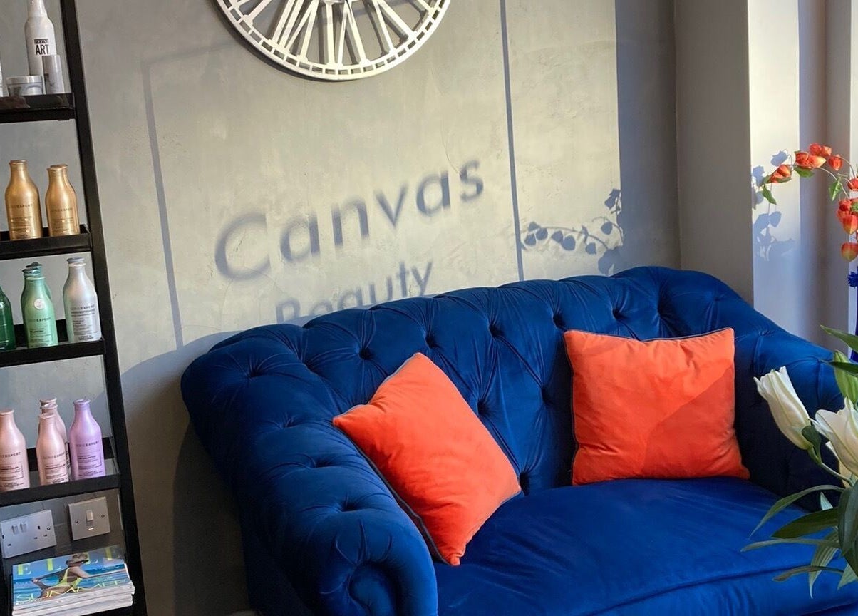 Cozy seating area at Canvas, York, England, GB with blue sofa and vibrant decor.