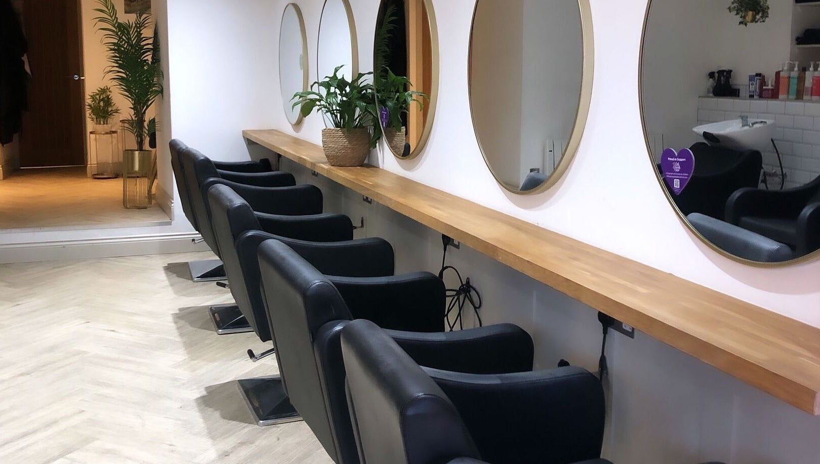 Elegant hairstyling setup at Salon Cabello, Otley, England, GB with mirrors and chairs.
