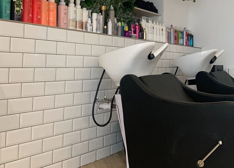 Modern wash stations at Salon Cabello, Otley, England, GB, with sleek design and quality hair products.