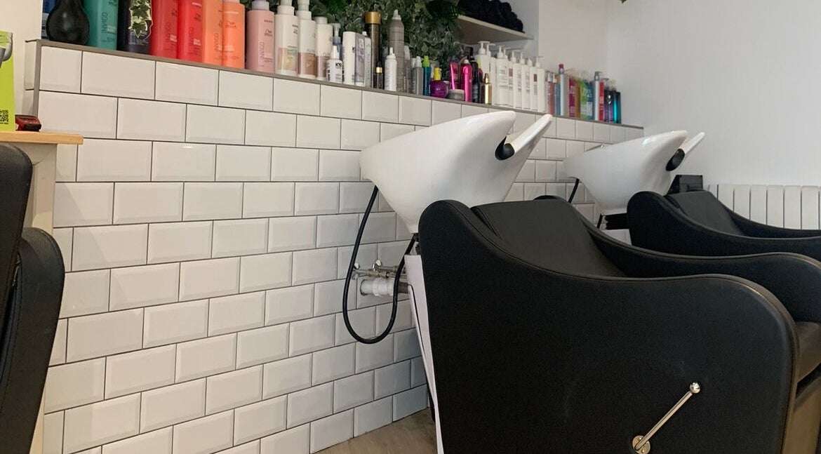 Modern wash stations at Salon Cabello, Otley, England, GB, with sleek design and quality hair products.