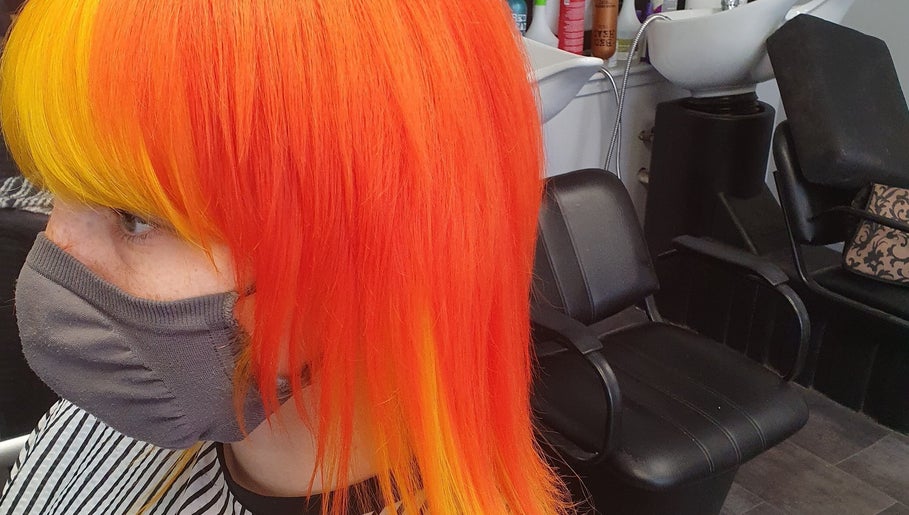 Hair by Christa in Grangemouth, Scotland, showcasing vibrant orange and yellow hairstyle transformation.