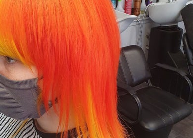 Hair by Christa in Grangemouth, Scotland, showcasing vibrant orange and yellow hairstyle transformation.