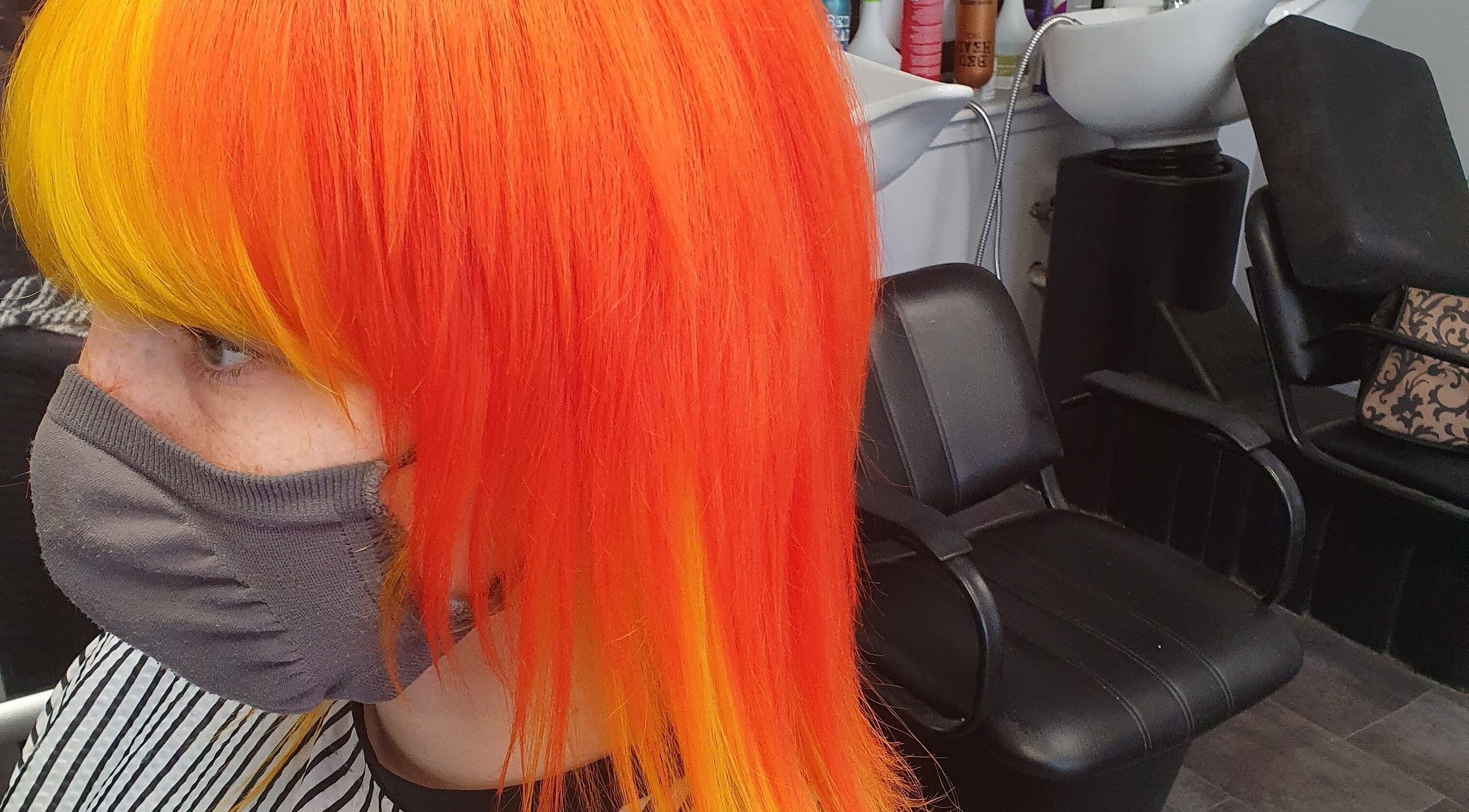 Hair by Christa in Grangemouth, Scotland, showcasing vibrant orange and yellow hairstyle transformation.