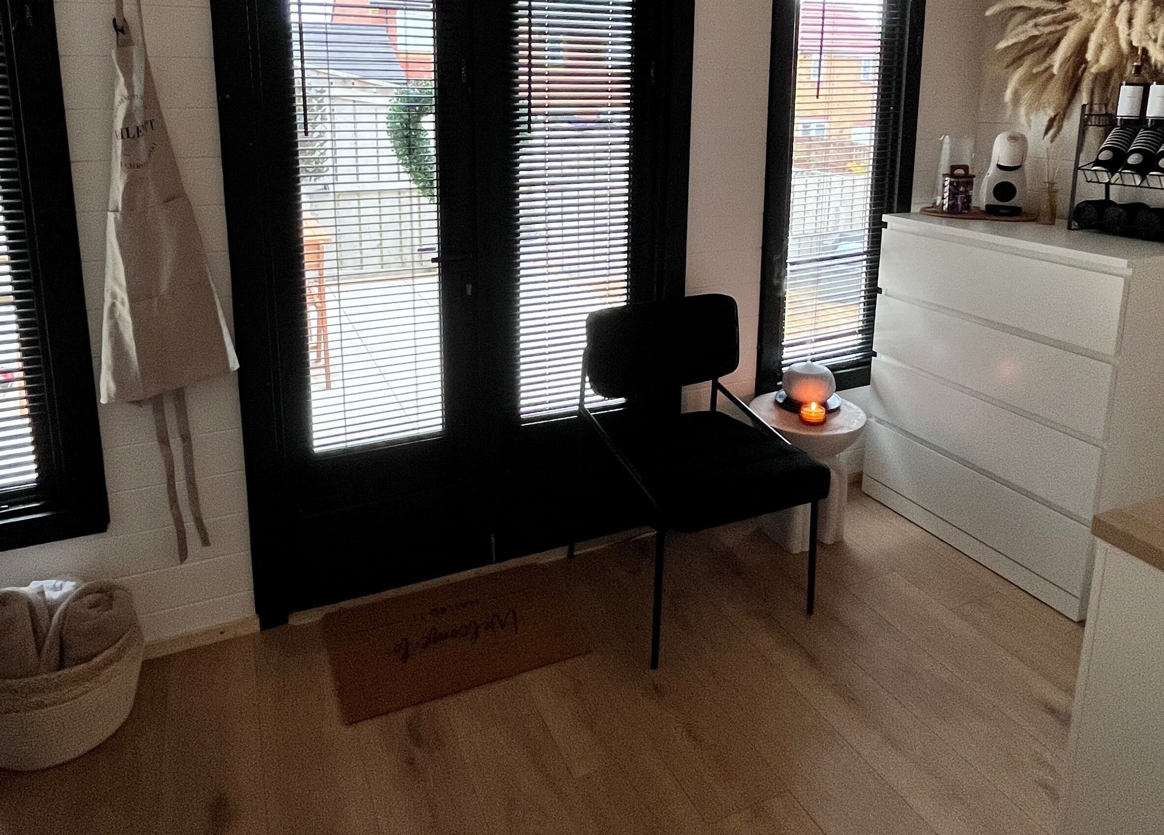 Cozy waiting area at Nailed it with Anna in Annfield Plain, England, GB with a chair, dresser, and decor.