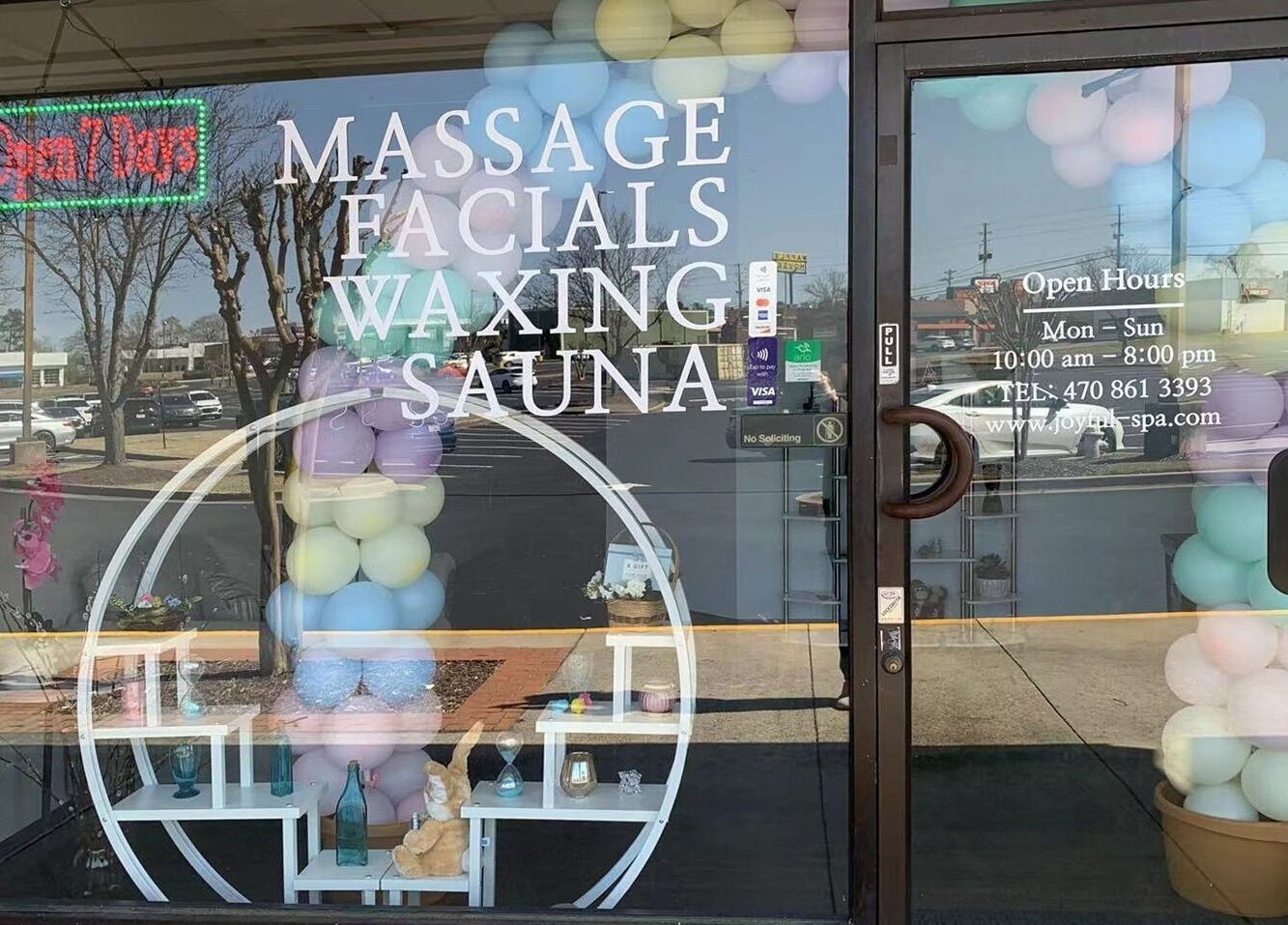 Front of Joyful Massage Day Spa LLC in Conyers, Georgia, US with open hours and colorful balloons.